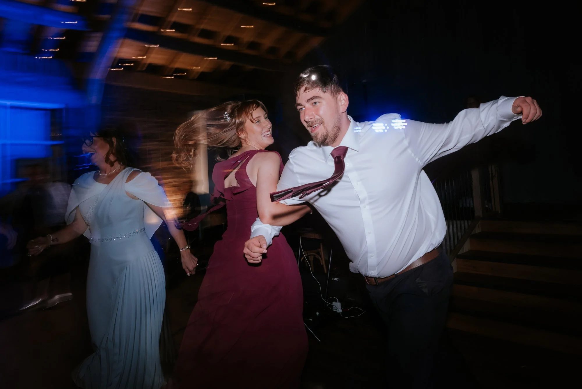 Guests throwing themselves into the Scottish ceilidh on the dance floor.