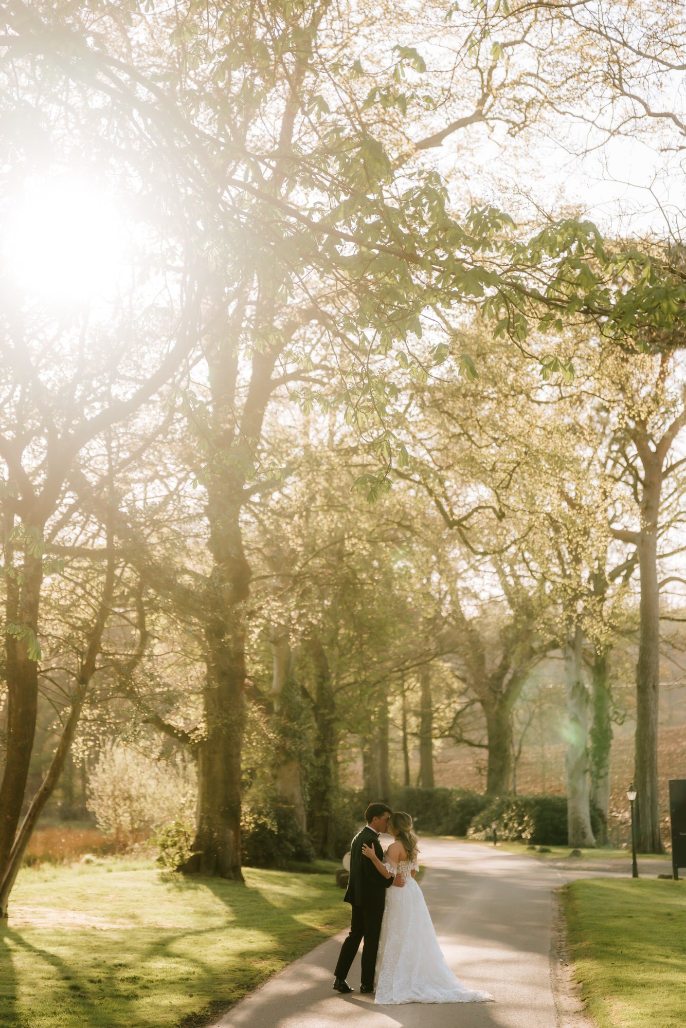 Ciara and Jonathon beneath the tall trees in the estate grounds.
