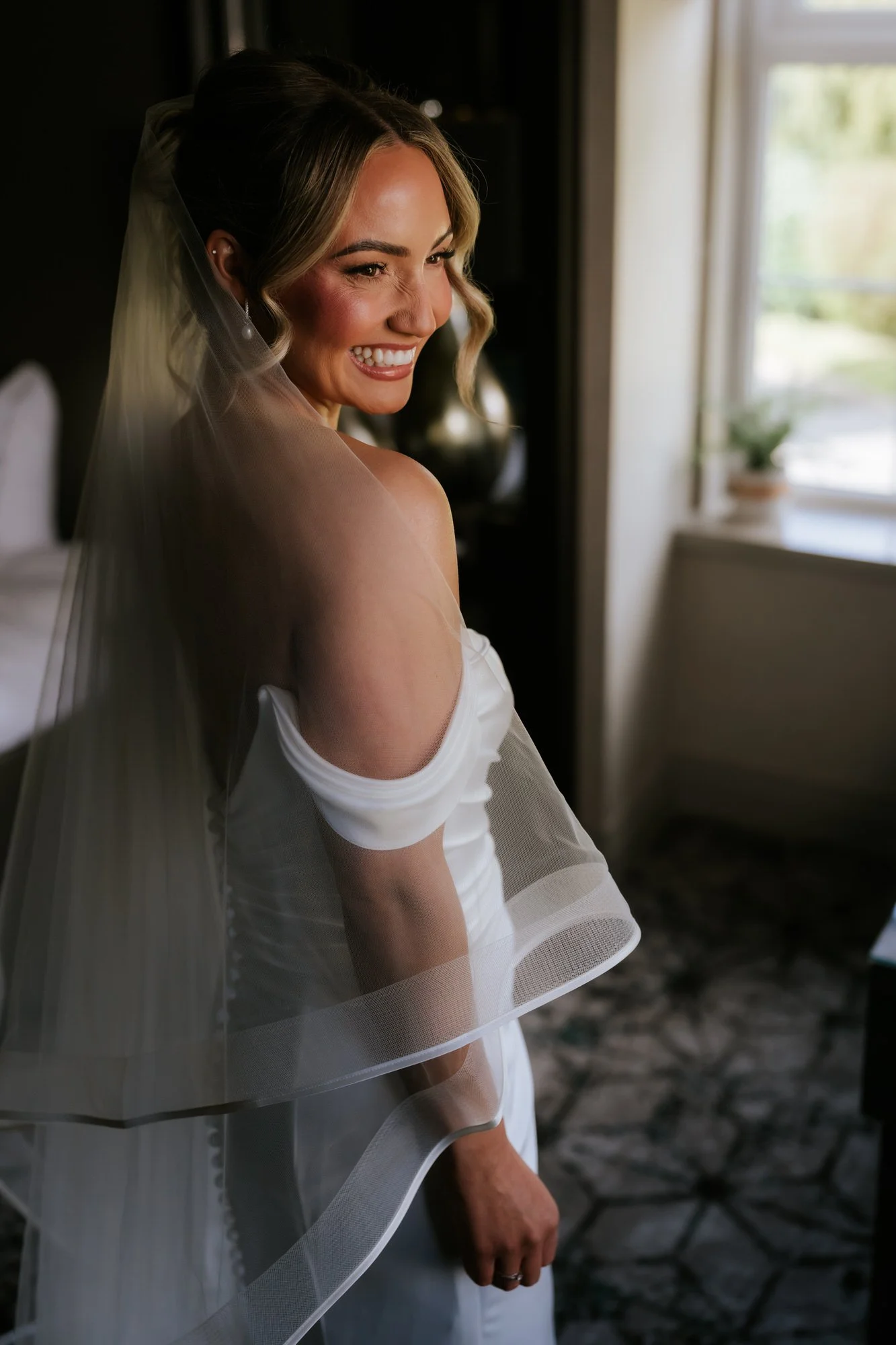 Elle smiling in her wedding dress and veil