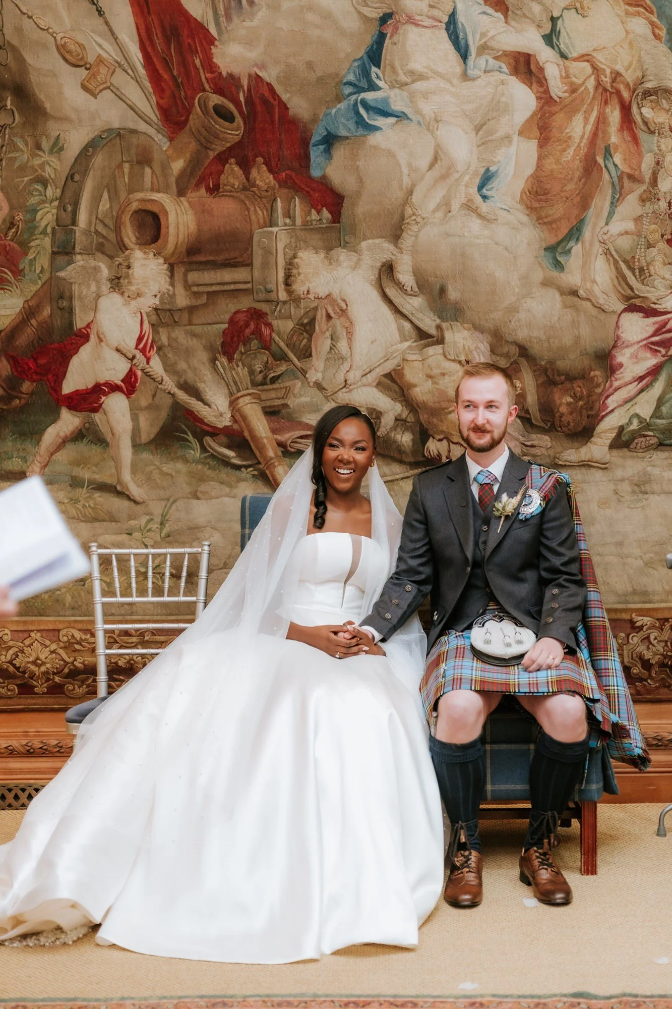 Kuda and Jamie seated together during their ceremony.