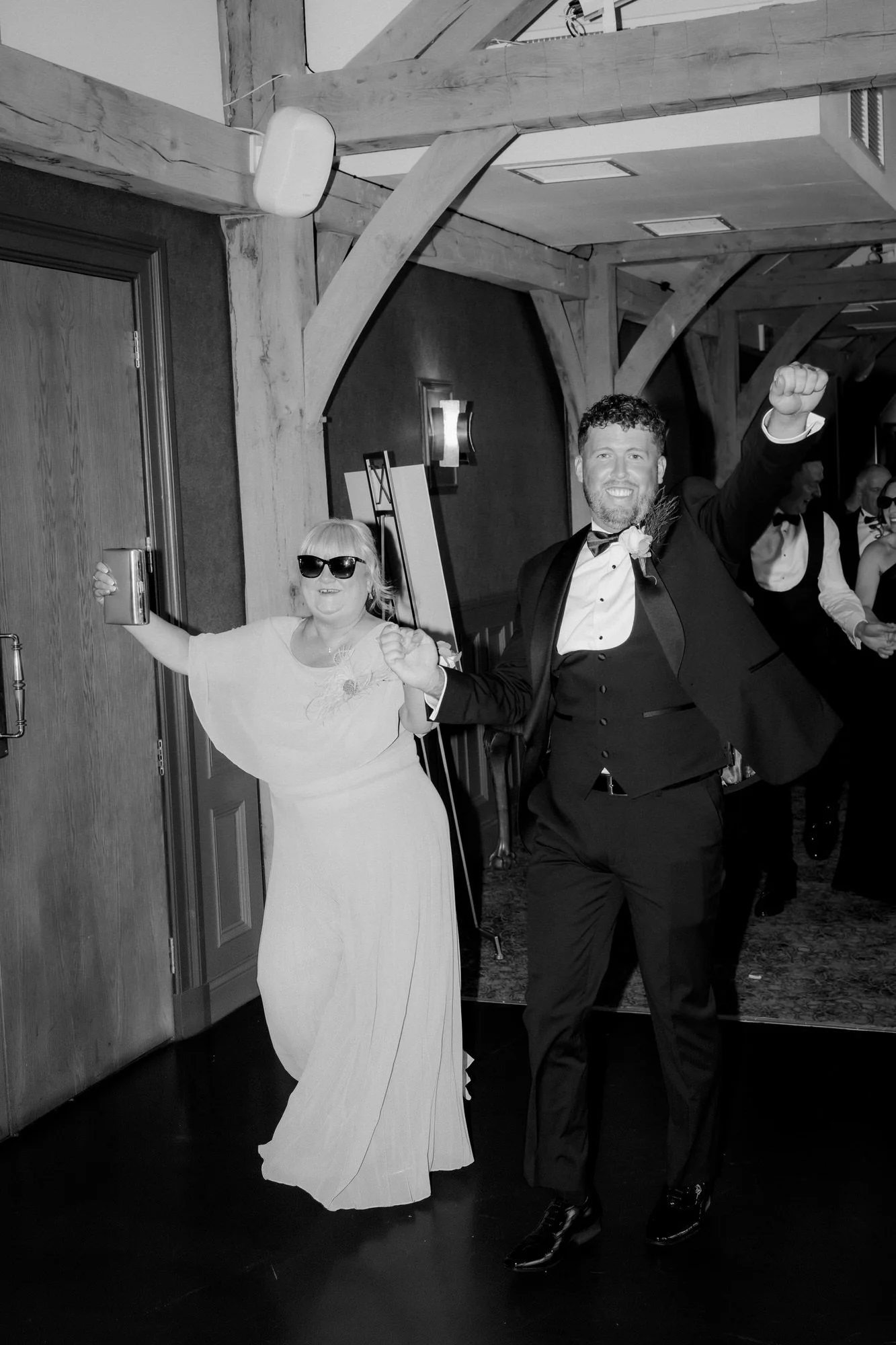 Wedding party members celebrating as they enter the reception.