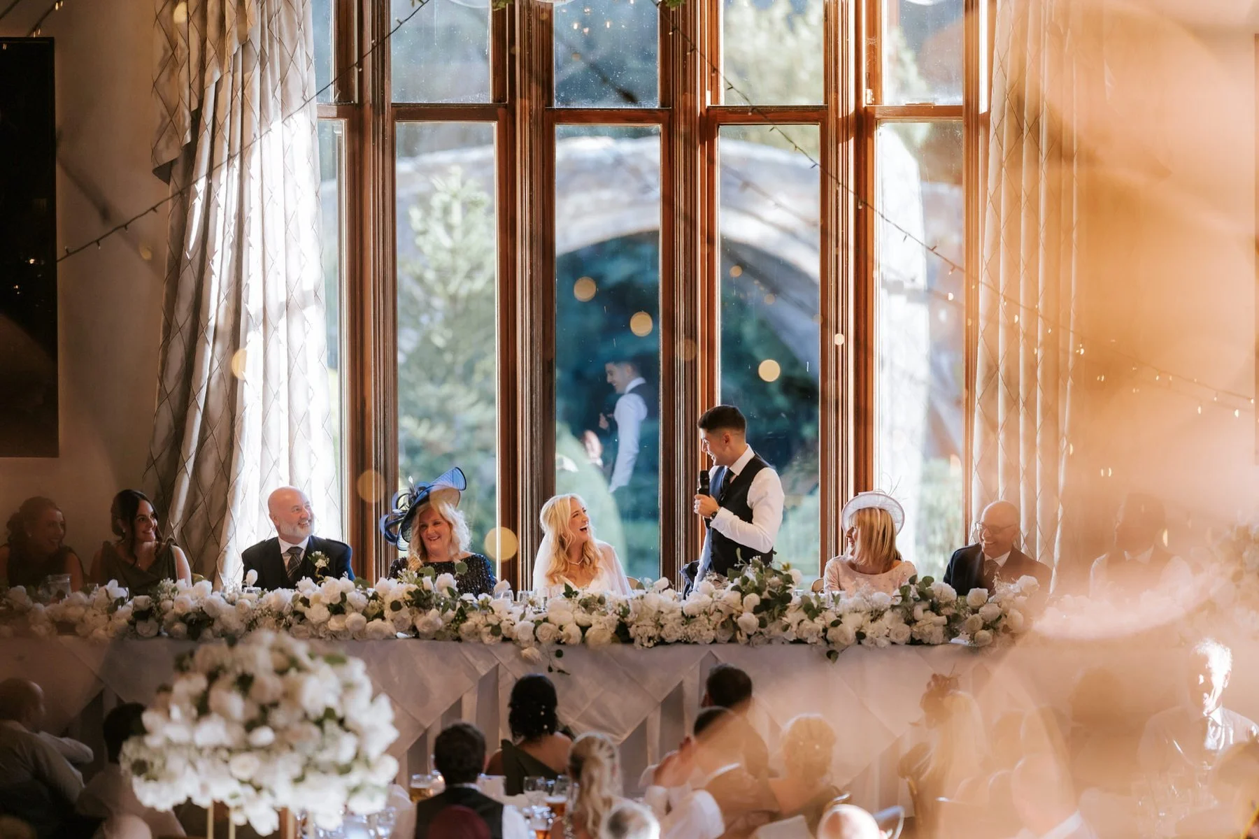 A speech at the top table beneath the tall ballroom windows at Brig o’ Doon.