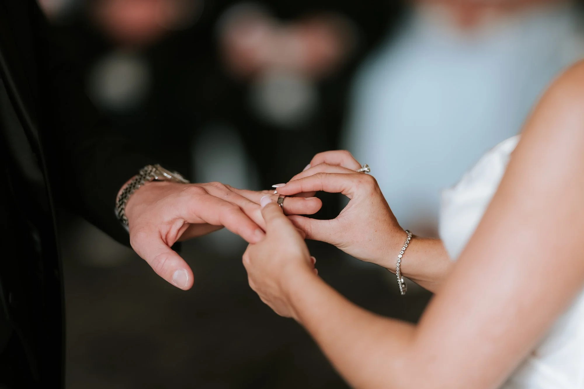 A close-up of the wedding ring exchange.