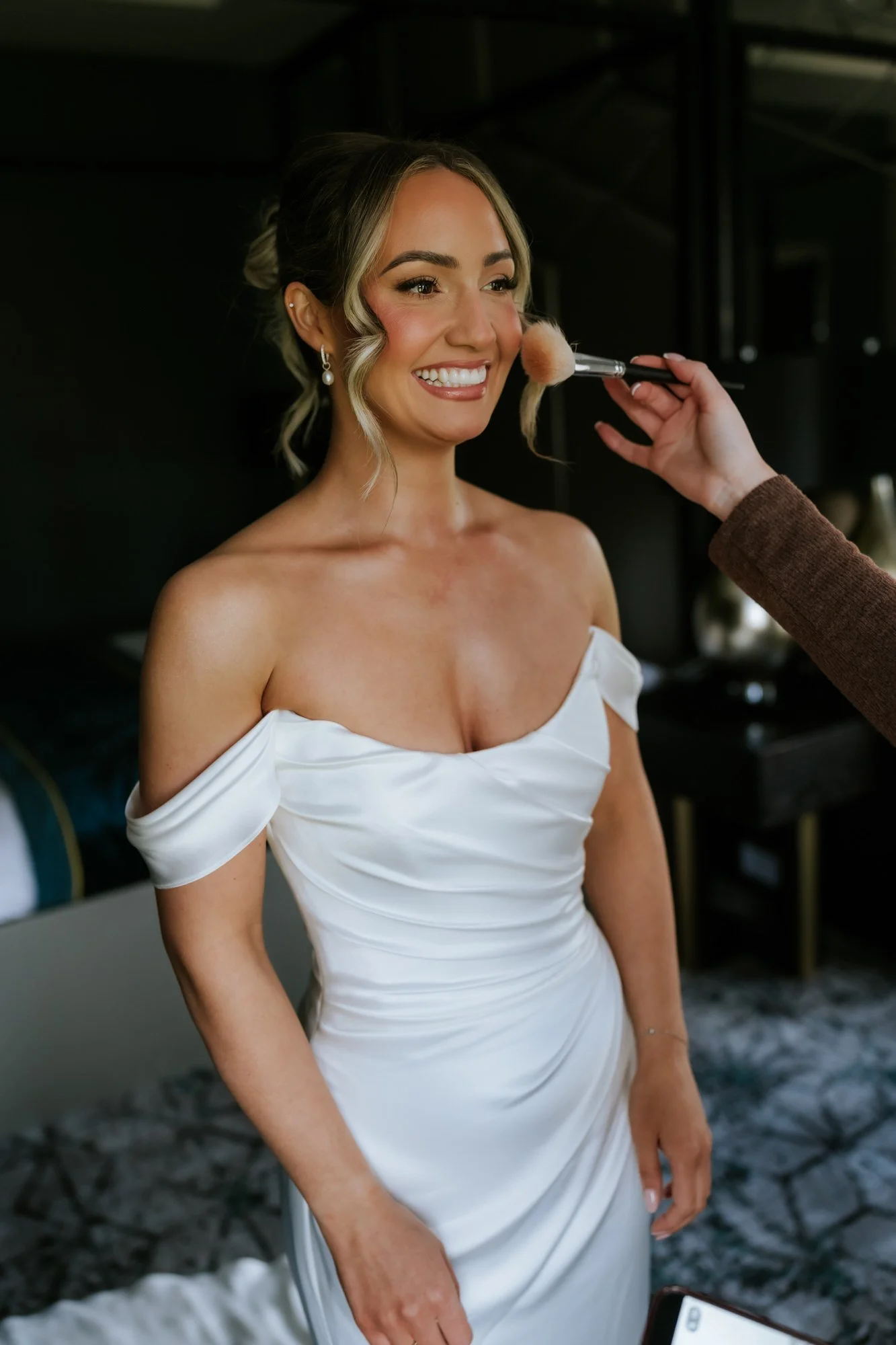 Elle smiling during the finishing touches to her makeup
