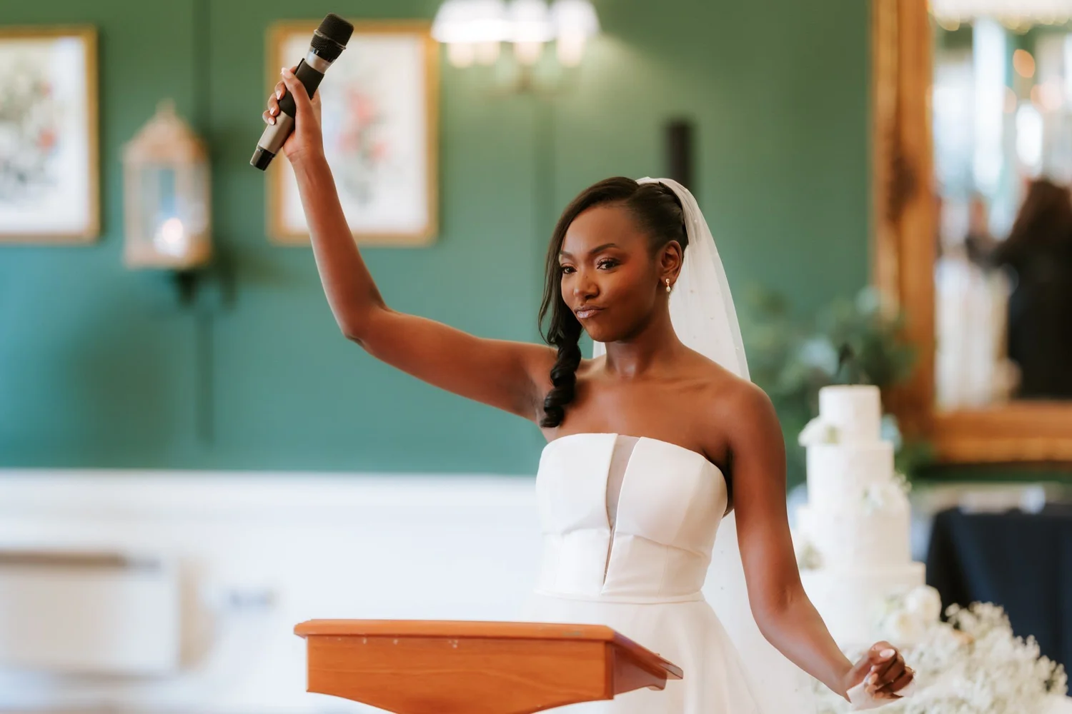 Kuda raising the microphone during her wedding speech.