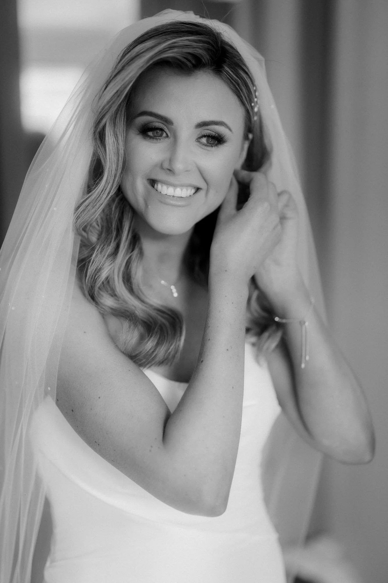 Black-and-white portrait of Natalie wearing her bridal earrings