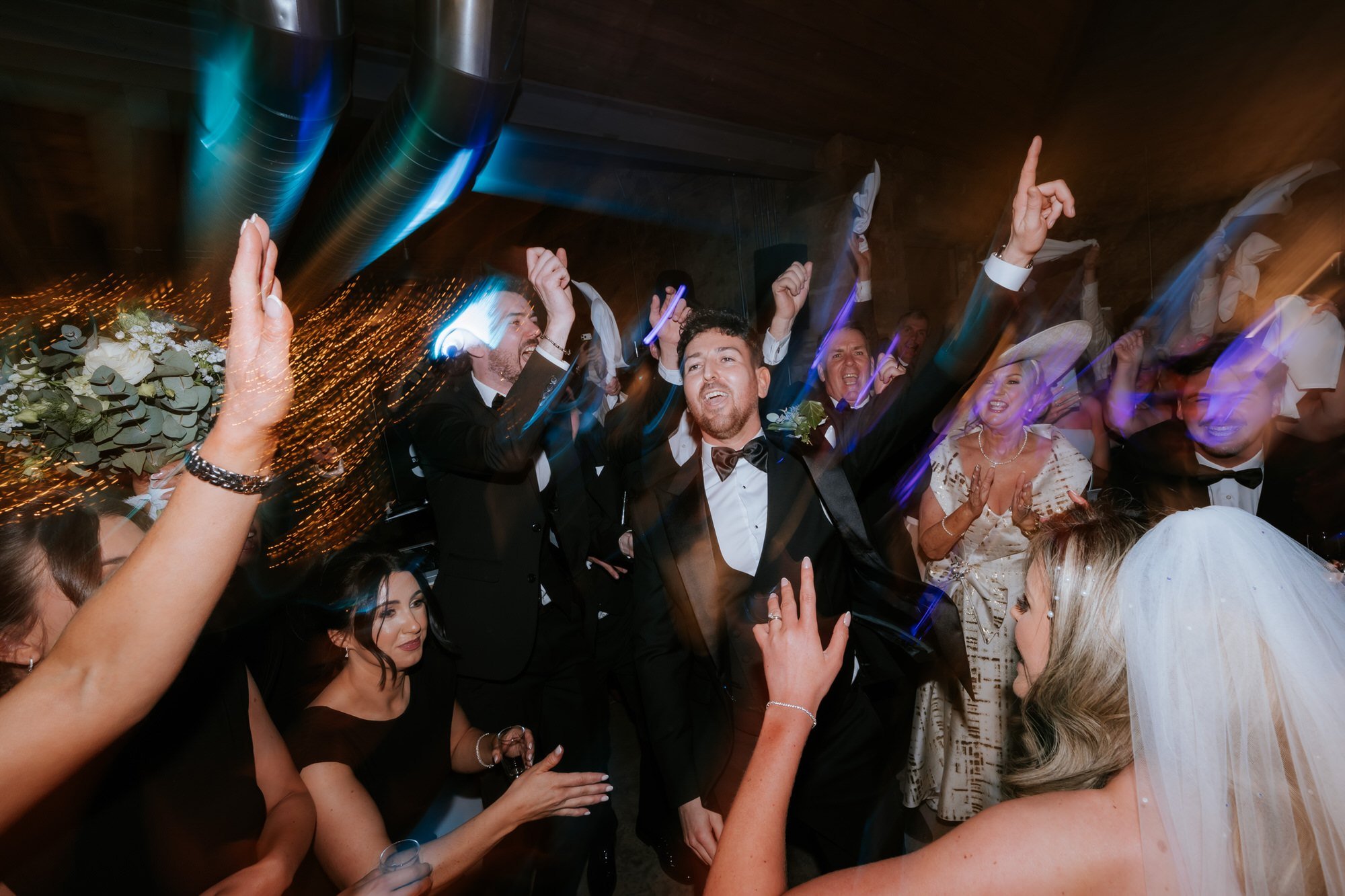 Jamie raising his arms during the wedding reception