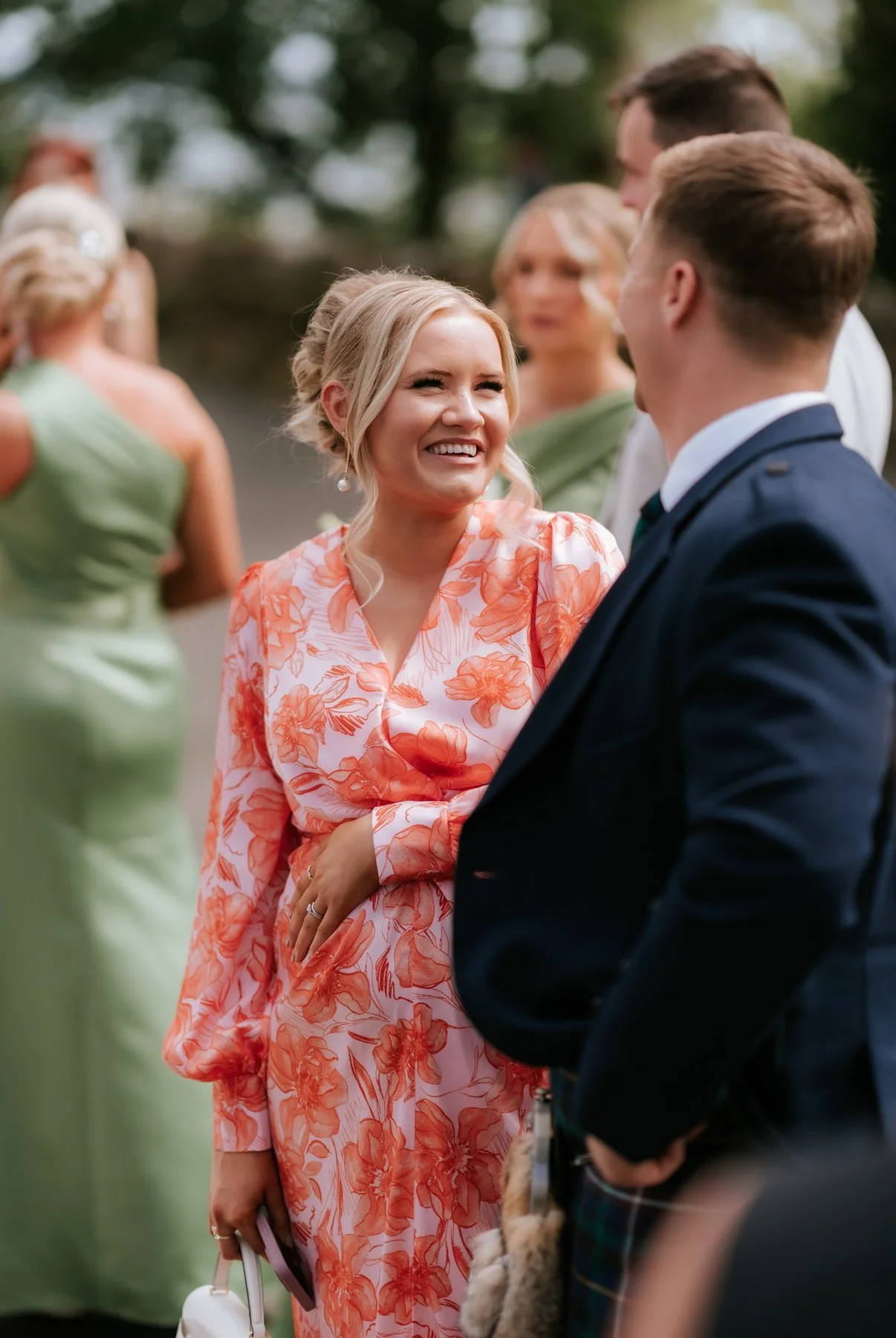 Wedding guests sharing a laugh together on the terrace at GG’s Yard.