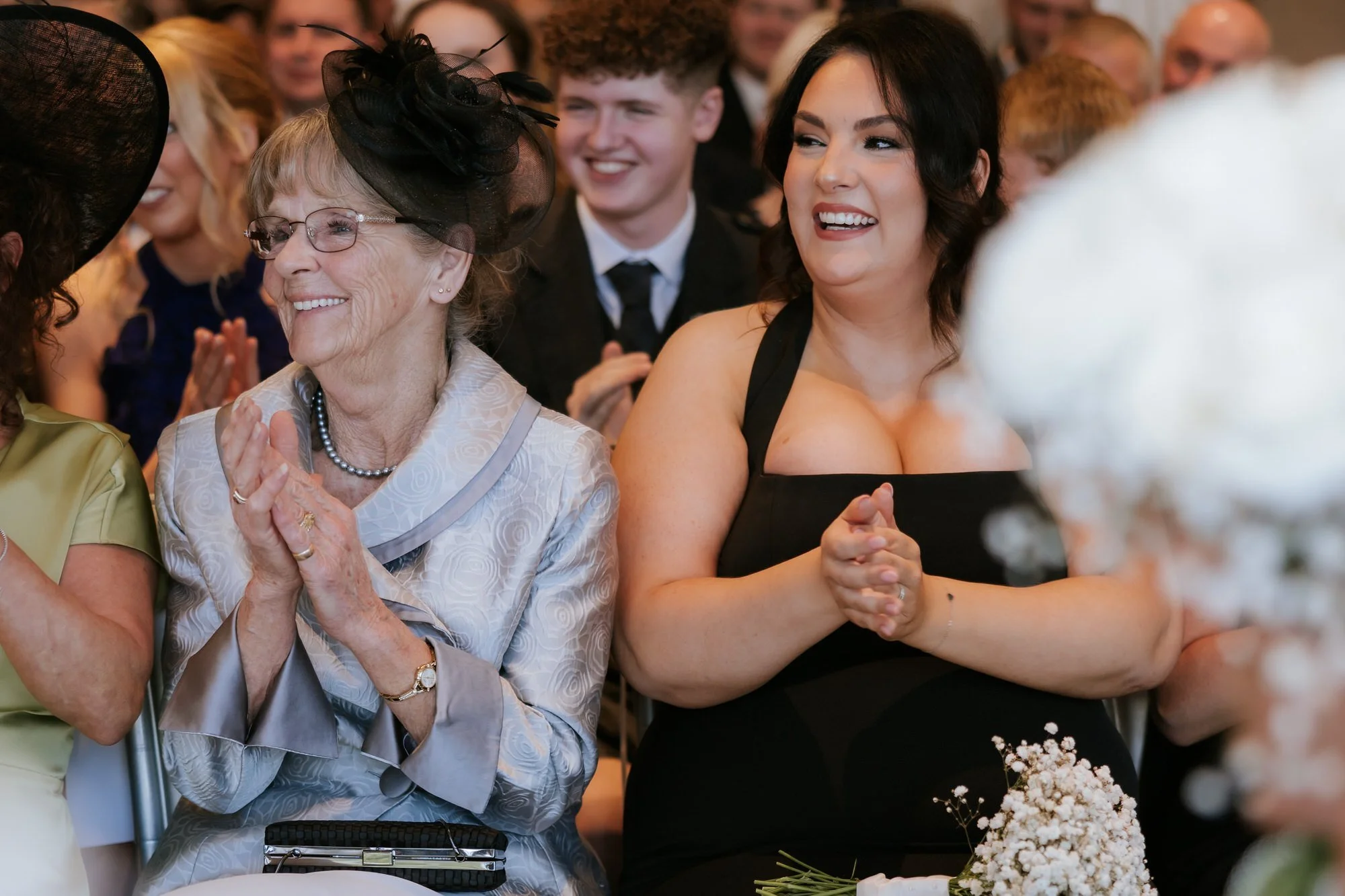 Wedding guests applauding during Elle and Adam's ceremony
