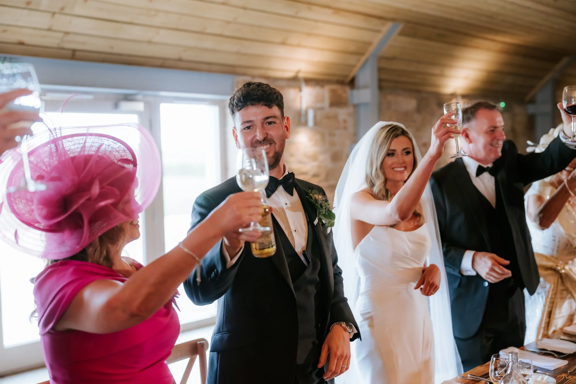 Natalie and Jamie raising their glasses for a toast