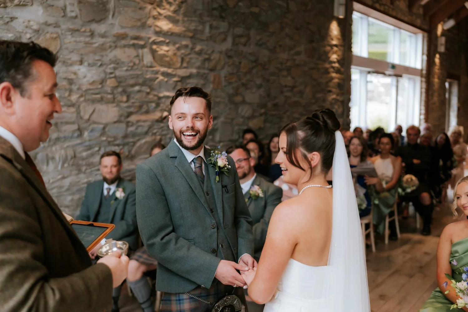 Lois and Dougie laughing during Alan Barr’s ceremony inside the stone-walled ceremony room at GG’s Yard.