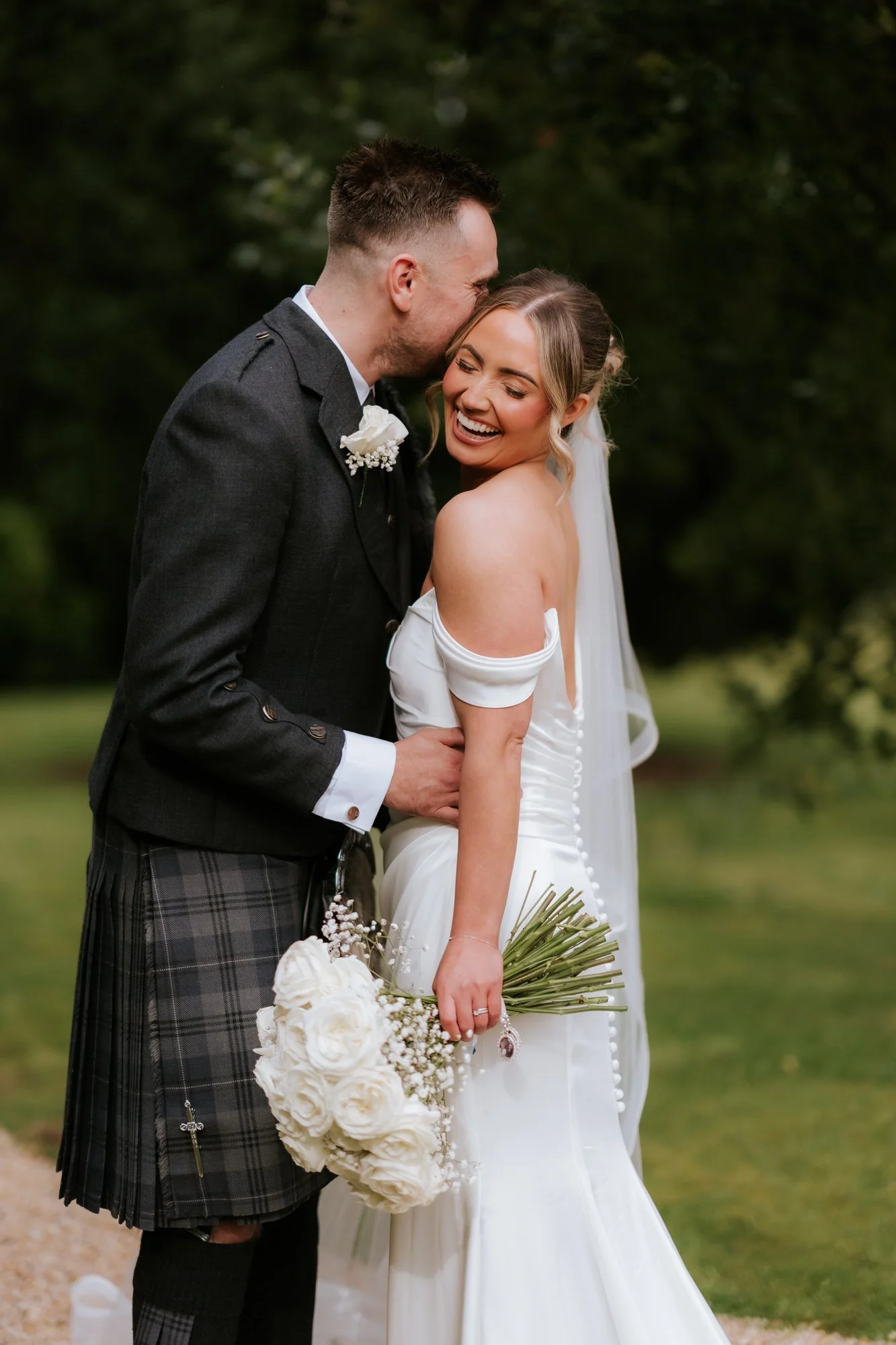 Elle laughing as Adam holds her close