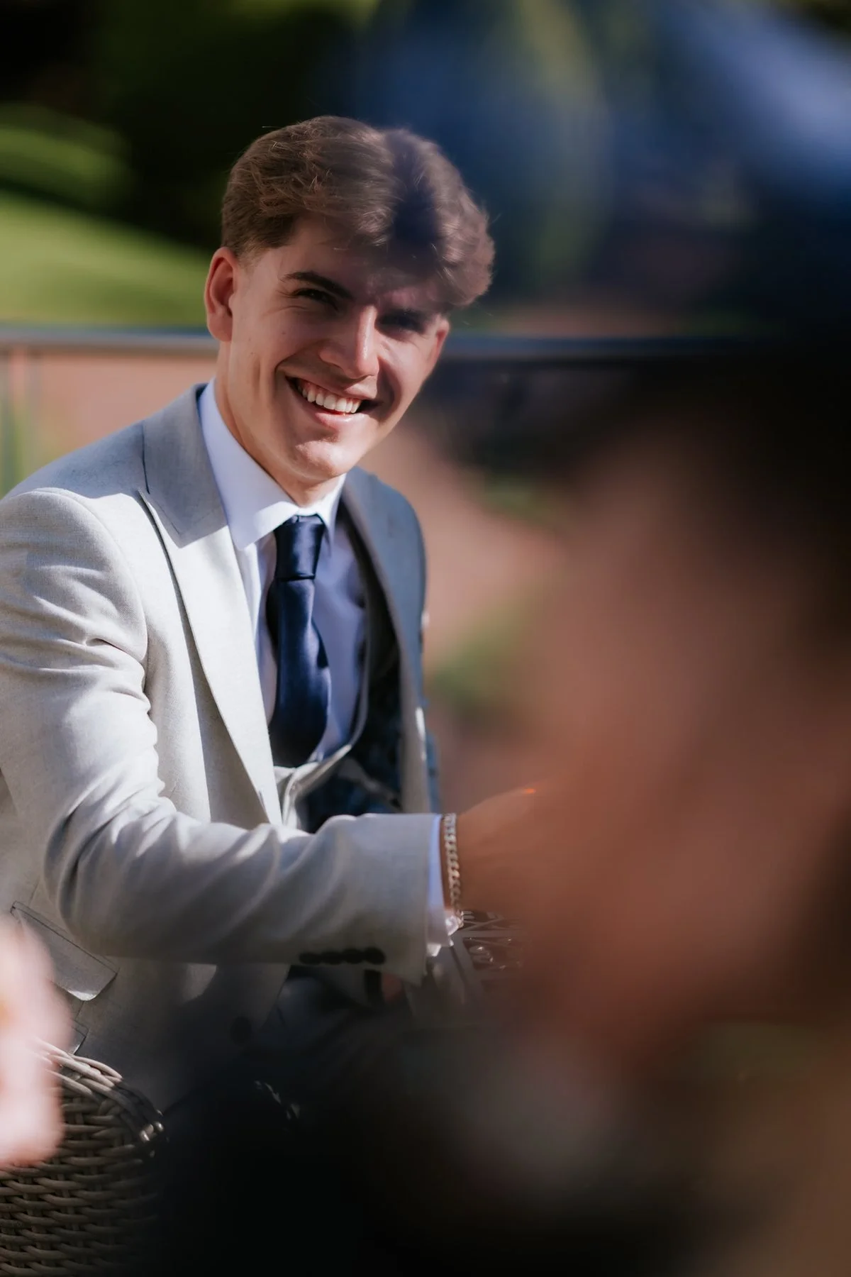 A guest laughing with friends during Lauren and Zen’s wedding reception.