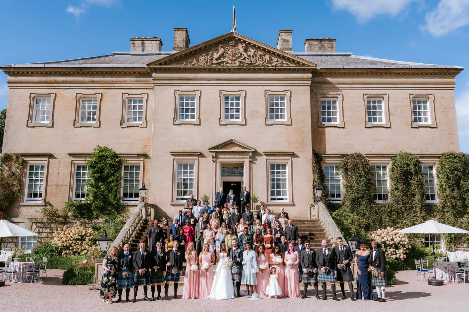 The whole wedding party gathered on the front steps of Dumfries House.