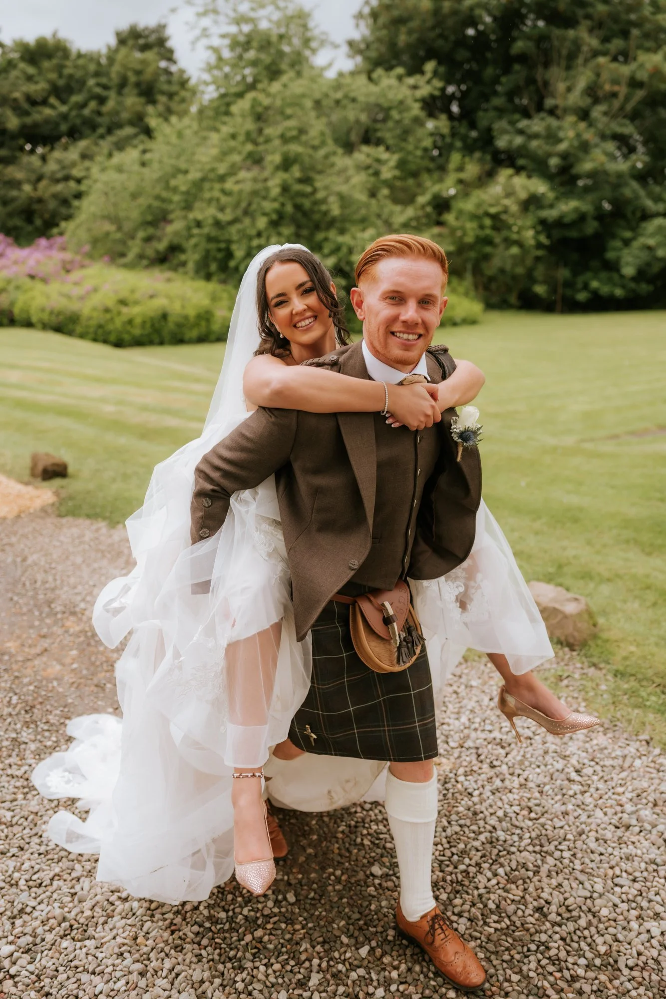 Scott giving Kaitlyn a piggyback beside the lawns at Glenbervie House.