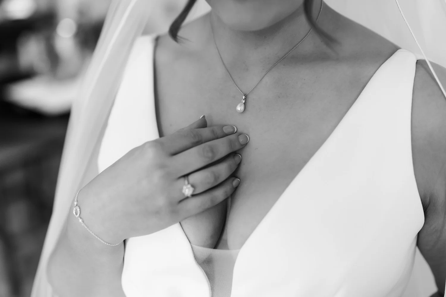 Black-and-white close-up of Kendall’s necklace and ring as she gets ready for her wedding.