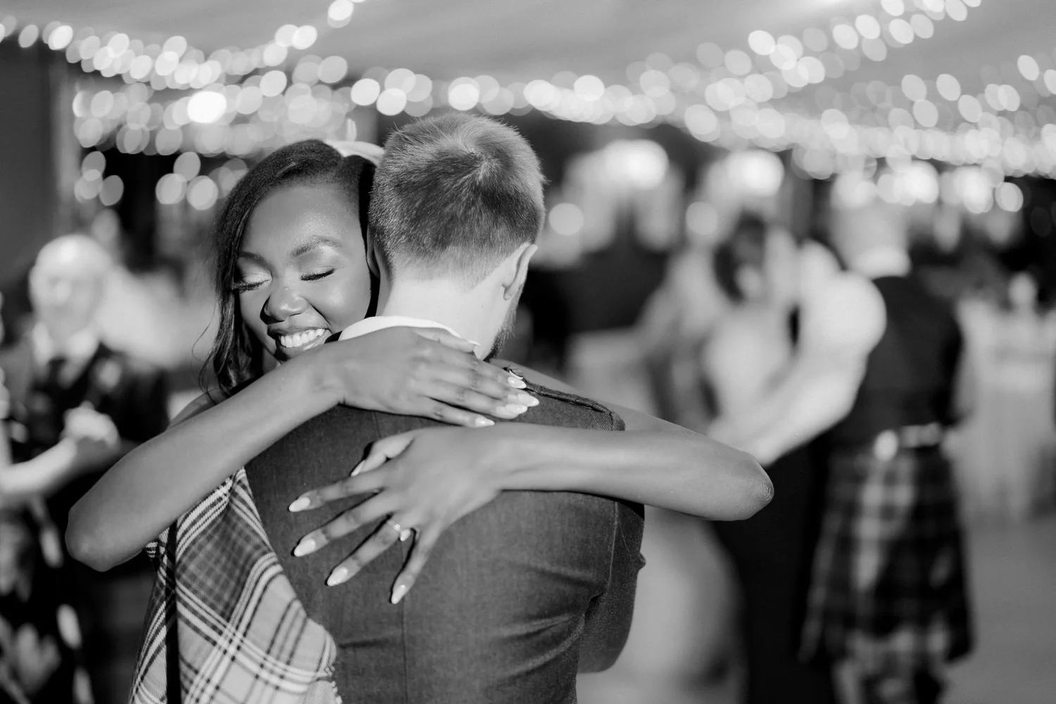 Kuda smiling over Jamie’s shoulder during their first dance.