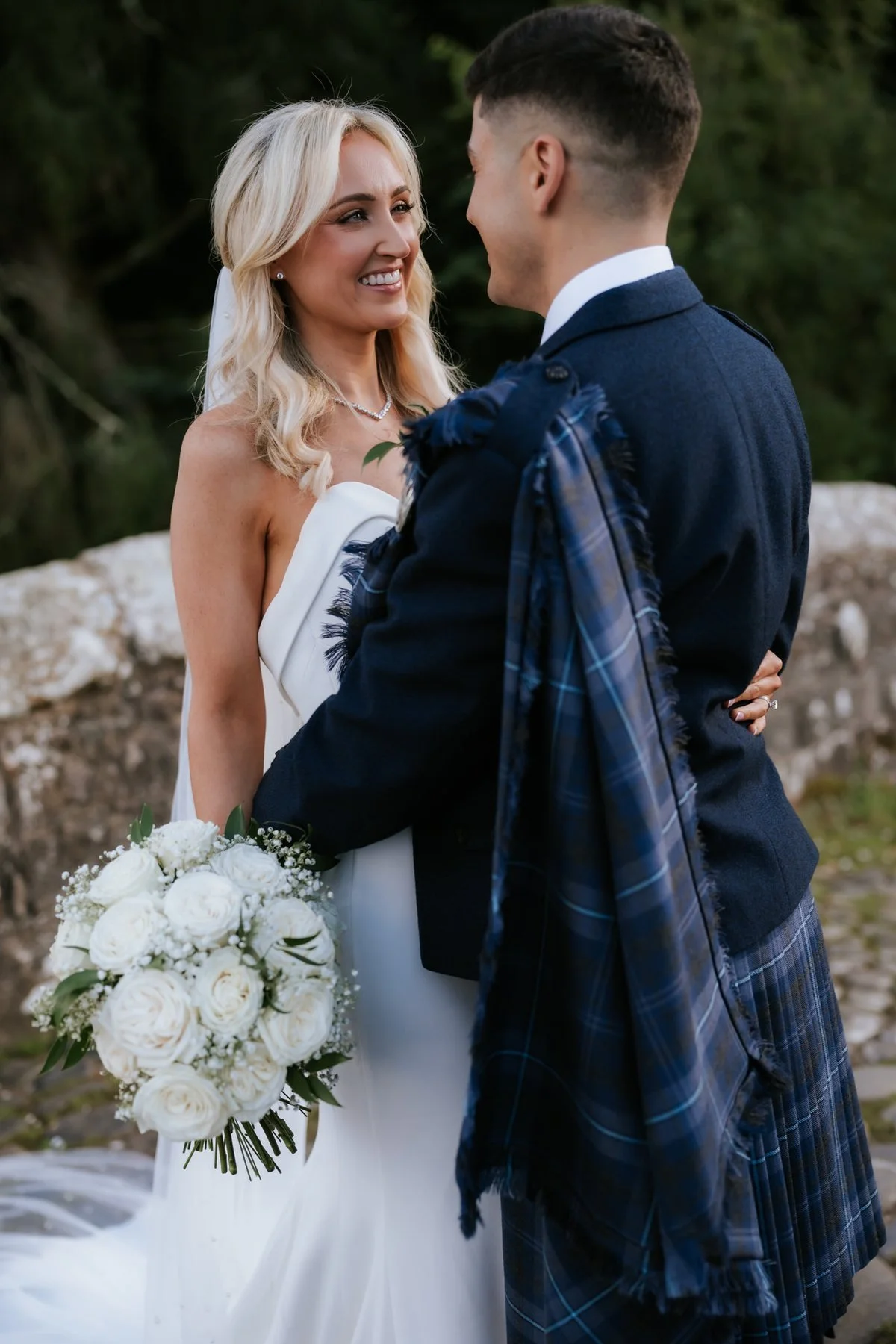 Lauren laughing with Zen during their wedding portraits on the bridge.