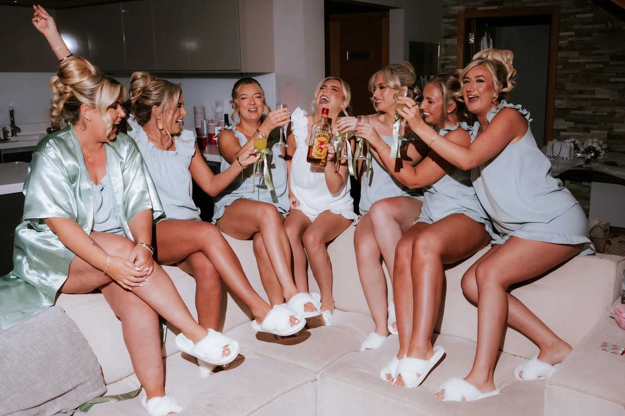 Taylor and her bridesmaids laughing together during preparations.