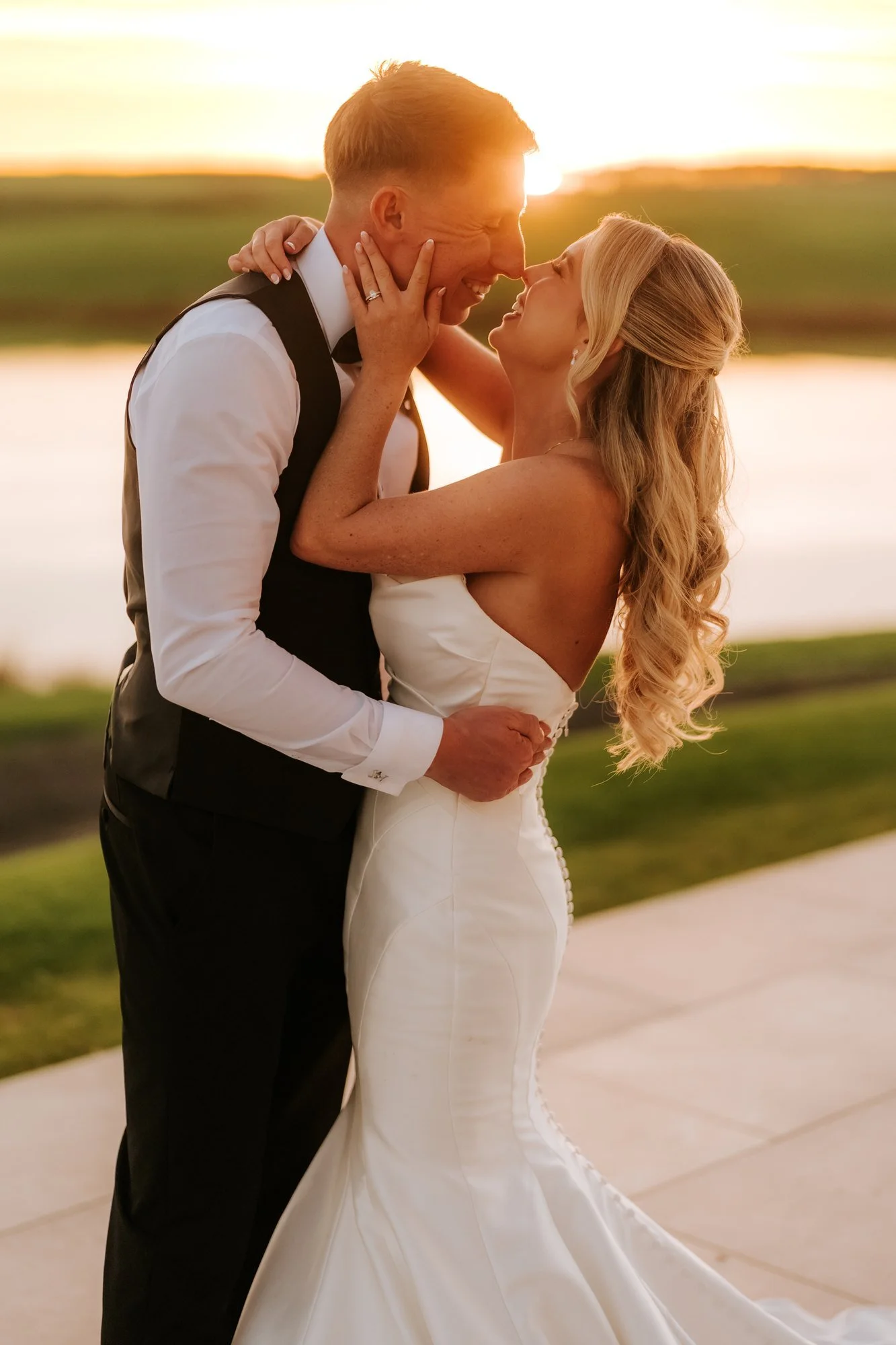 Aiden and Taylor embracing in golden sunset light.