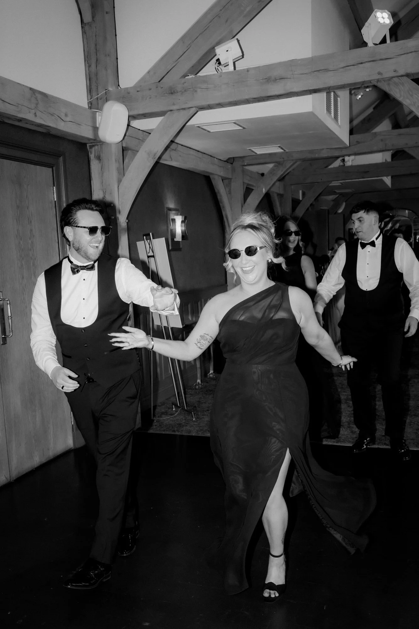 A bridesmaid and groomsman arriving for the wedding breakfast.