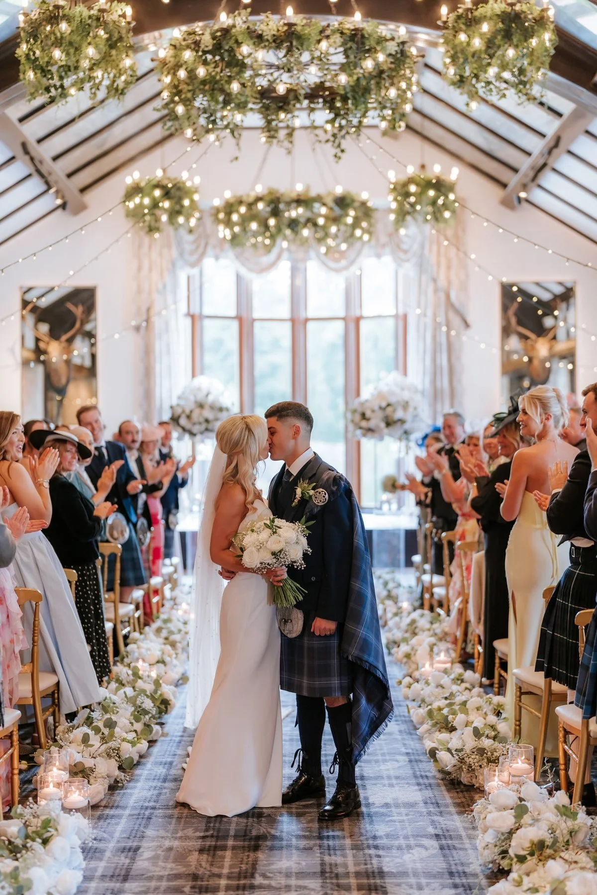 Lauren and Zen walking back up the aisle together as their guests applaud.