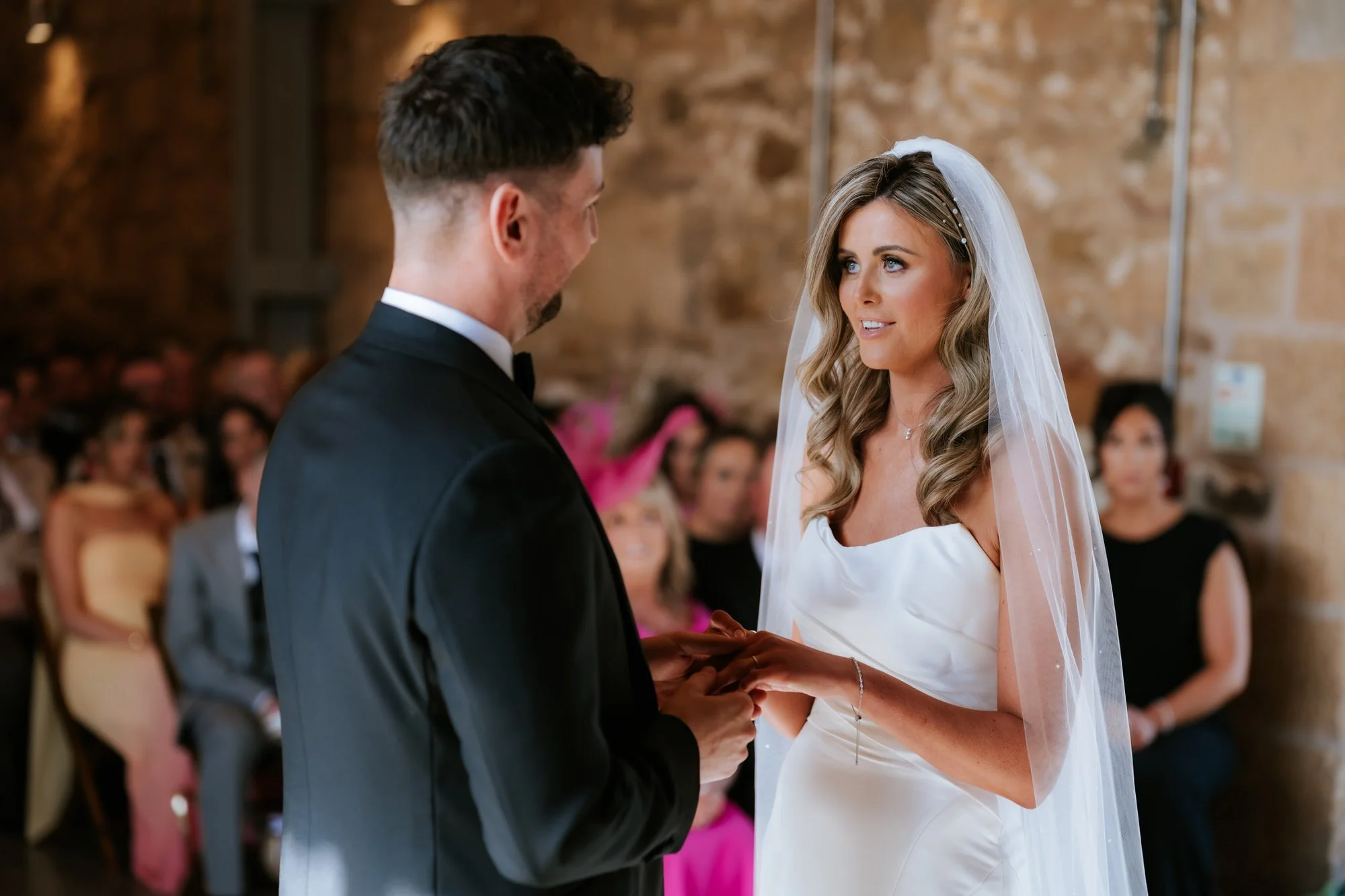 Natalie and Jamie exchanging a wedding ring