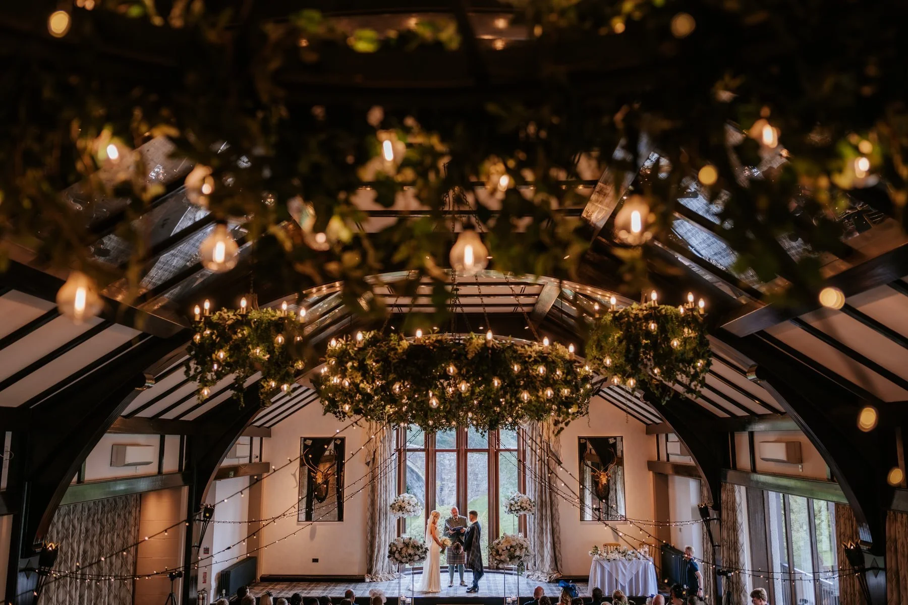 Greenery, chandeliers and flowers decorating the timber-framed ballroom at Brig o’ Doon.