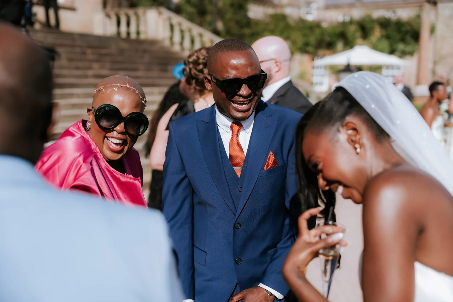 Kuda laughing with guests in the gardens during the drinks reception.