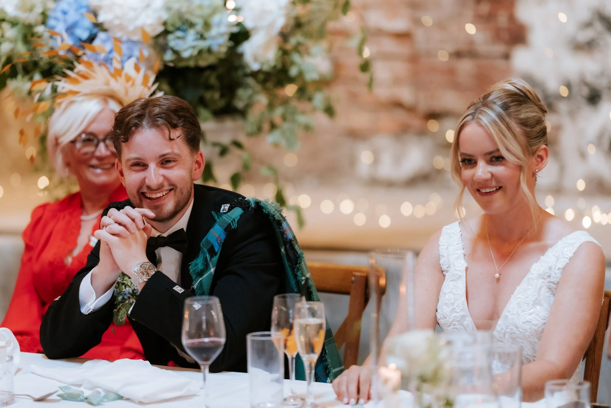 Luke and Lilian laughing together at the top table.