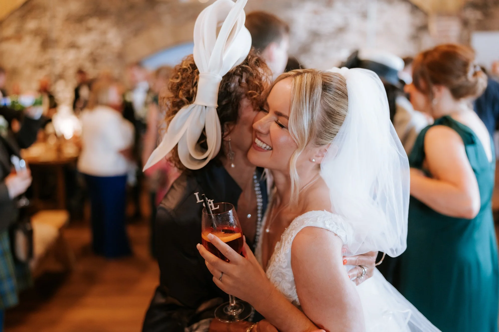 Lilian greeting a guest with a hug during the drinks reception.