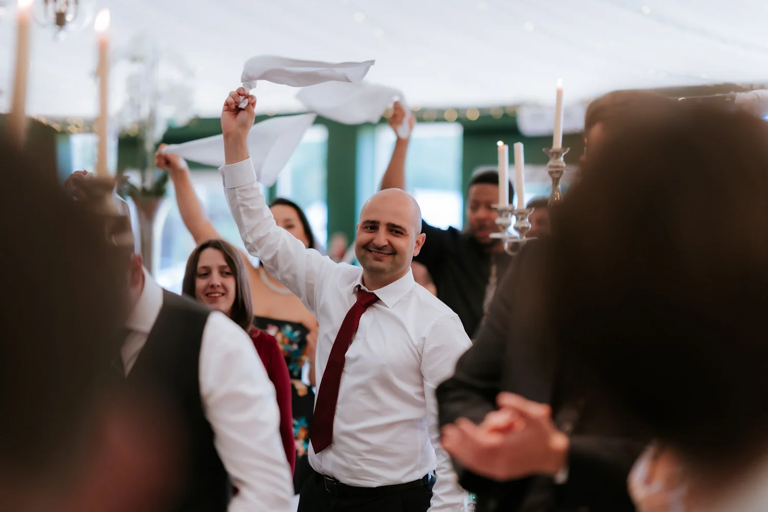 A guest waving a napkin at the wedding breakfast.