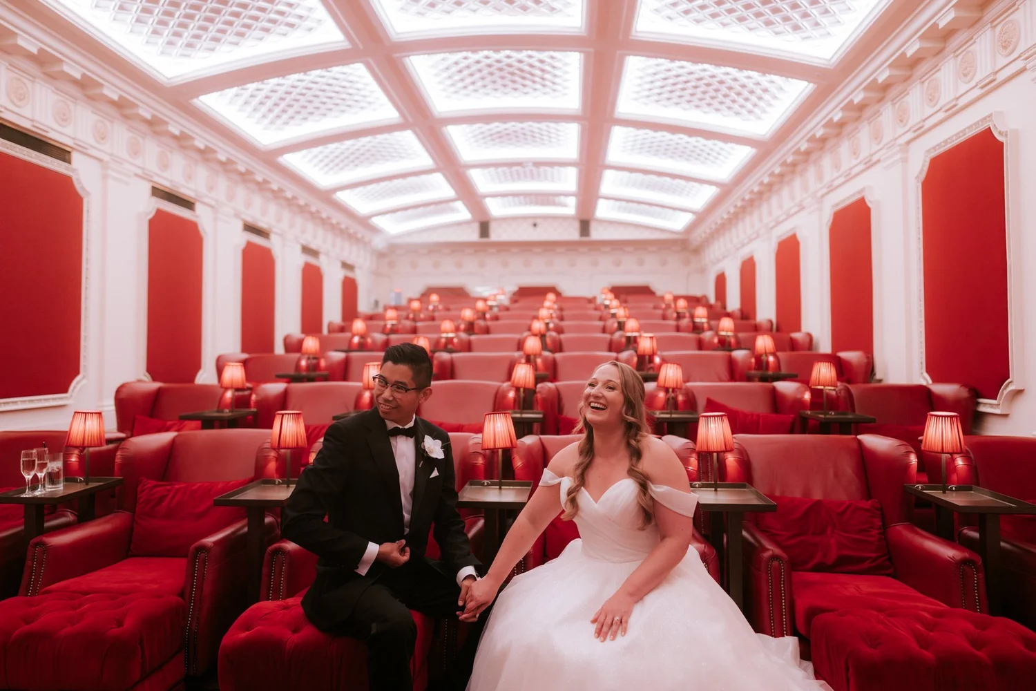 Allie and Carl laughing together in the red seats of The Scotsman Picturehouse cinema.