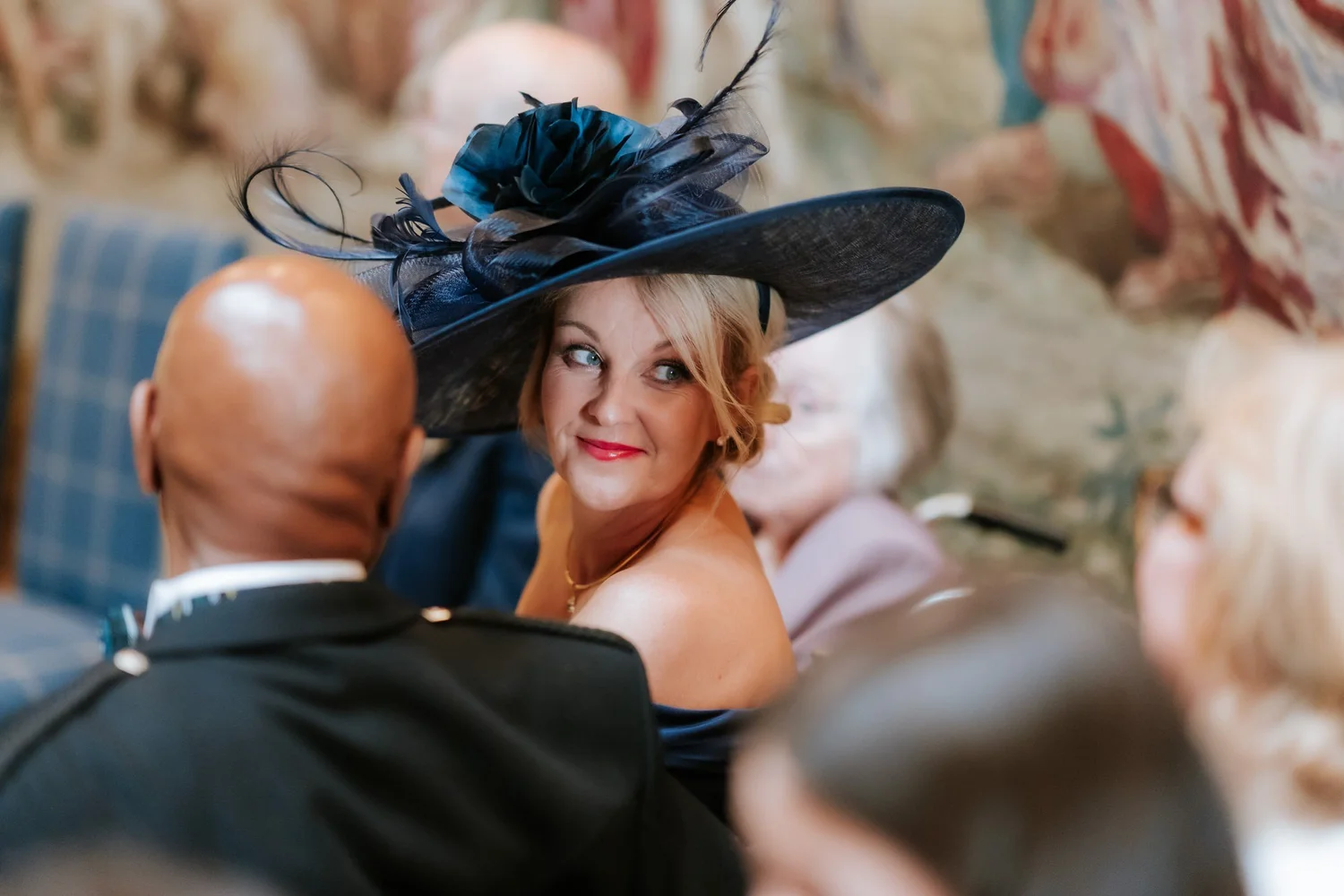 Wedding guests seated in the Tapestry Room before the ceremony.