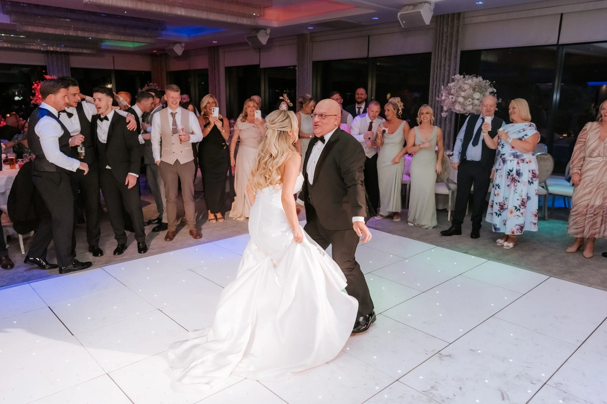 Aiden and Taylor dancing as their guests look on.