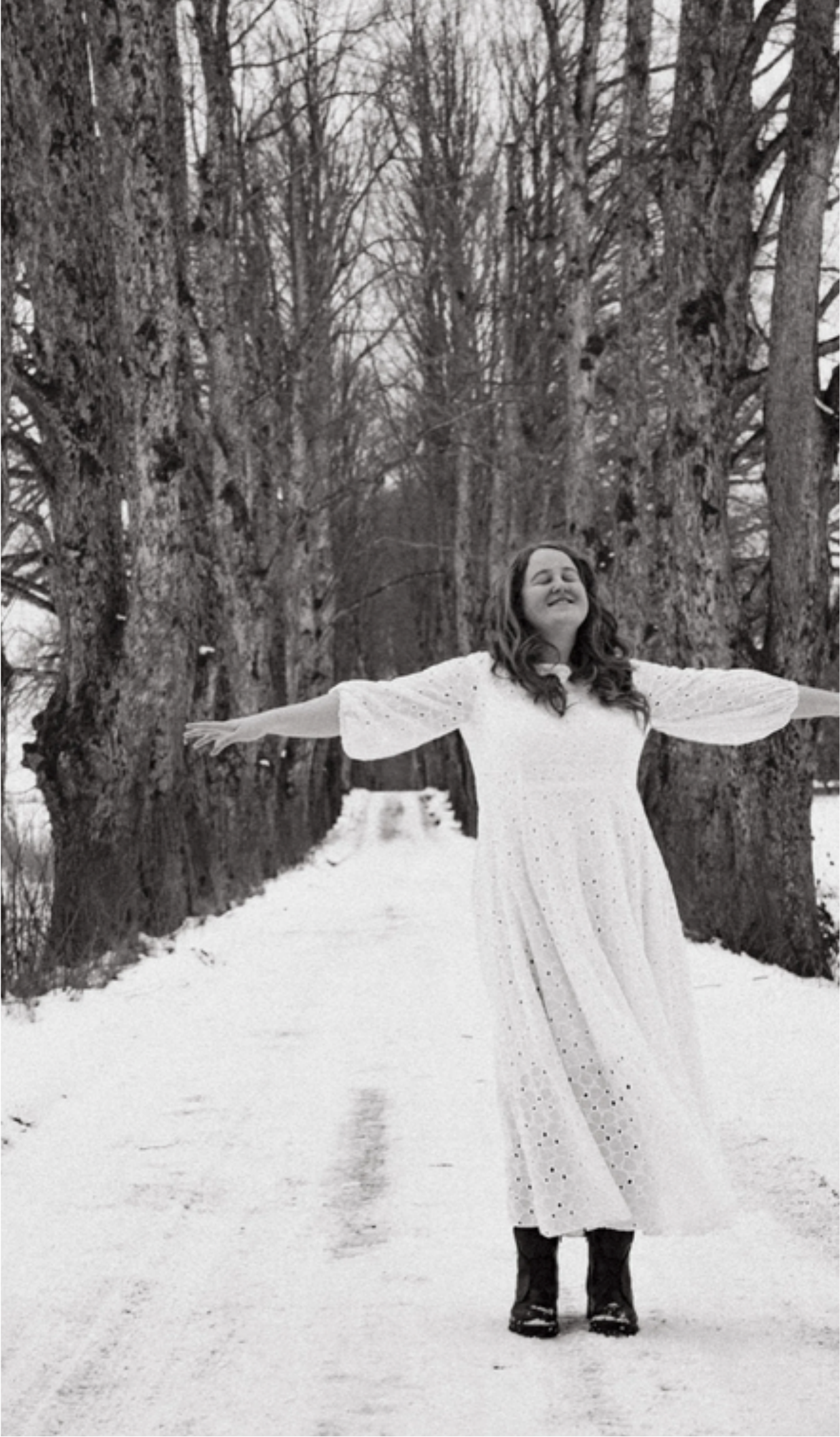 Sondra standing in a snowy forest