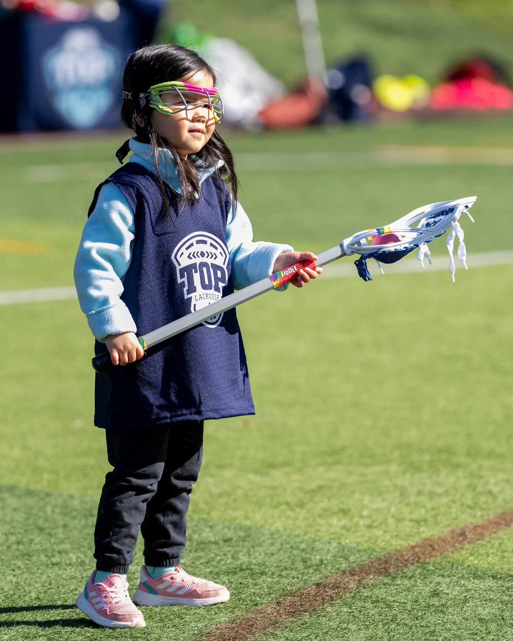 Children playing lacrosse in spring