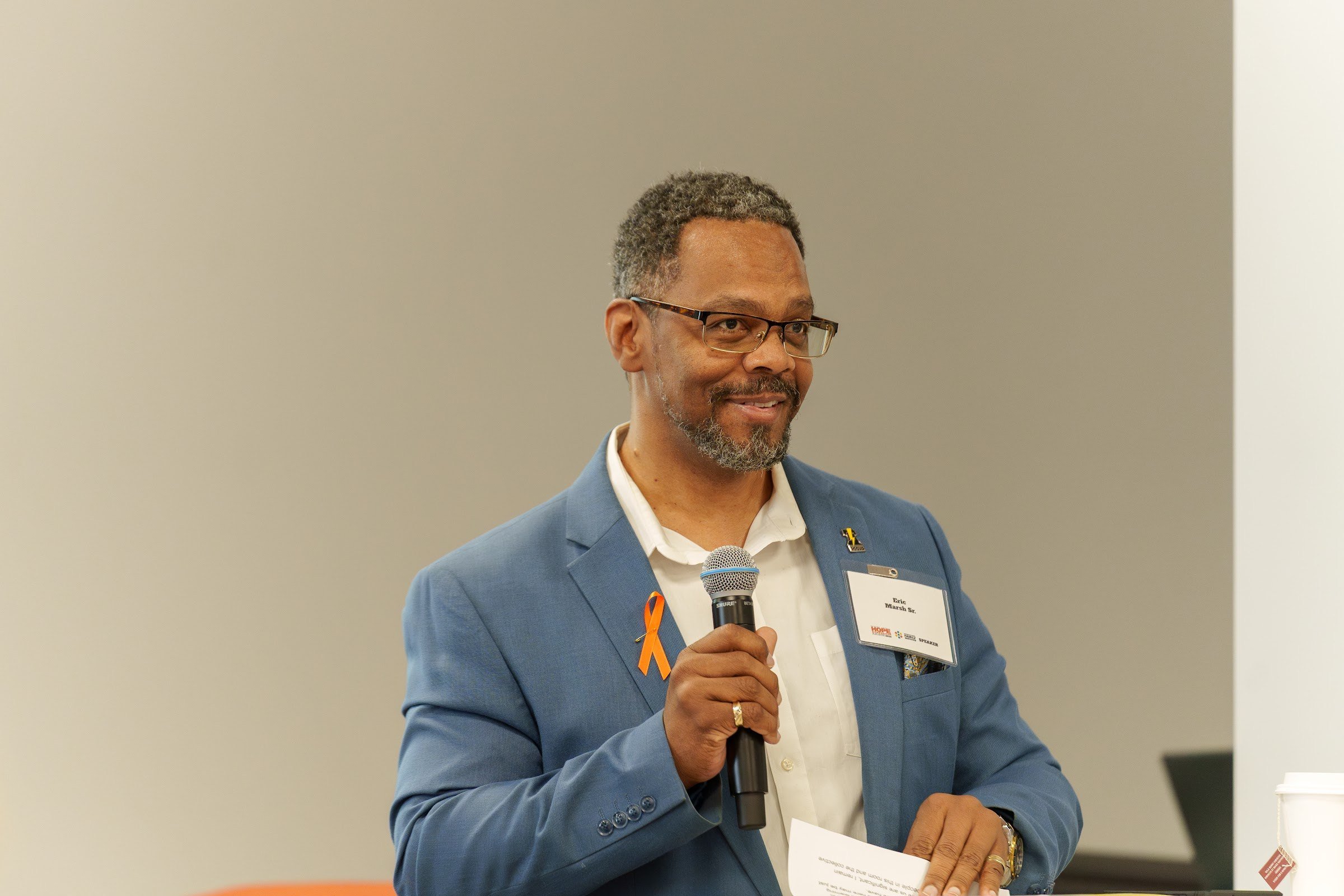 A panellist speaking into the microphone