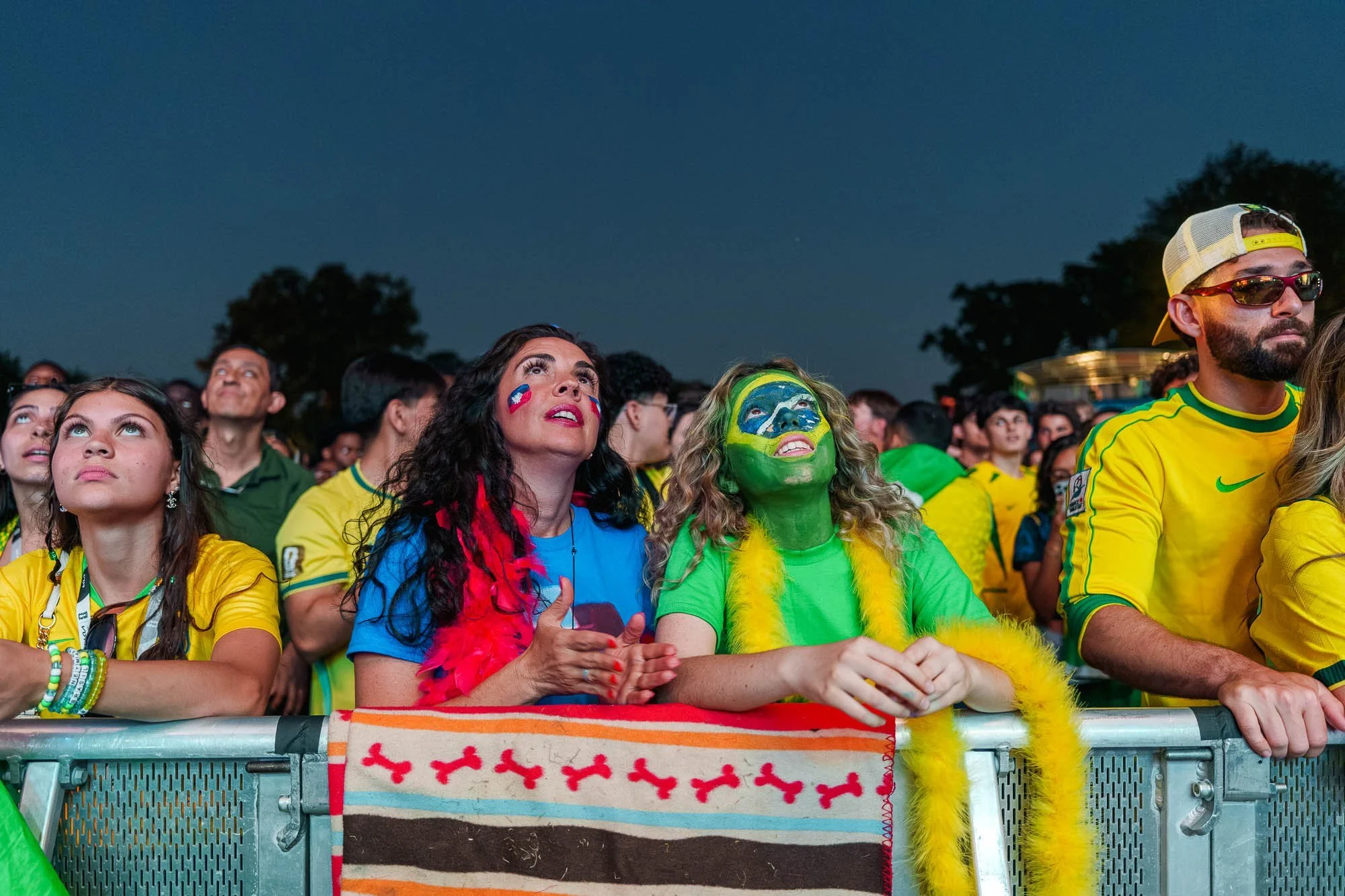 Supporters in flags and face paint at the barrier
