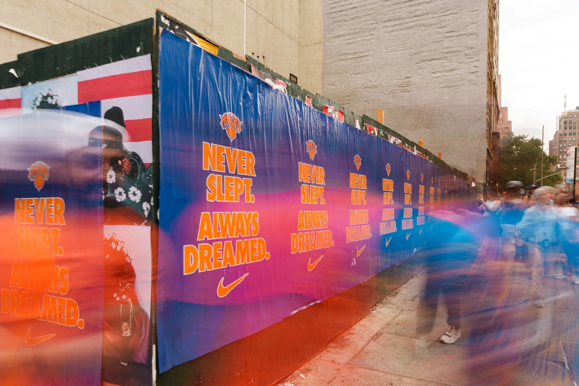 Fans moving past a mural along the parade route