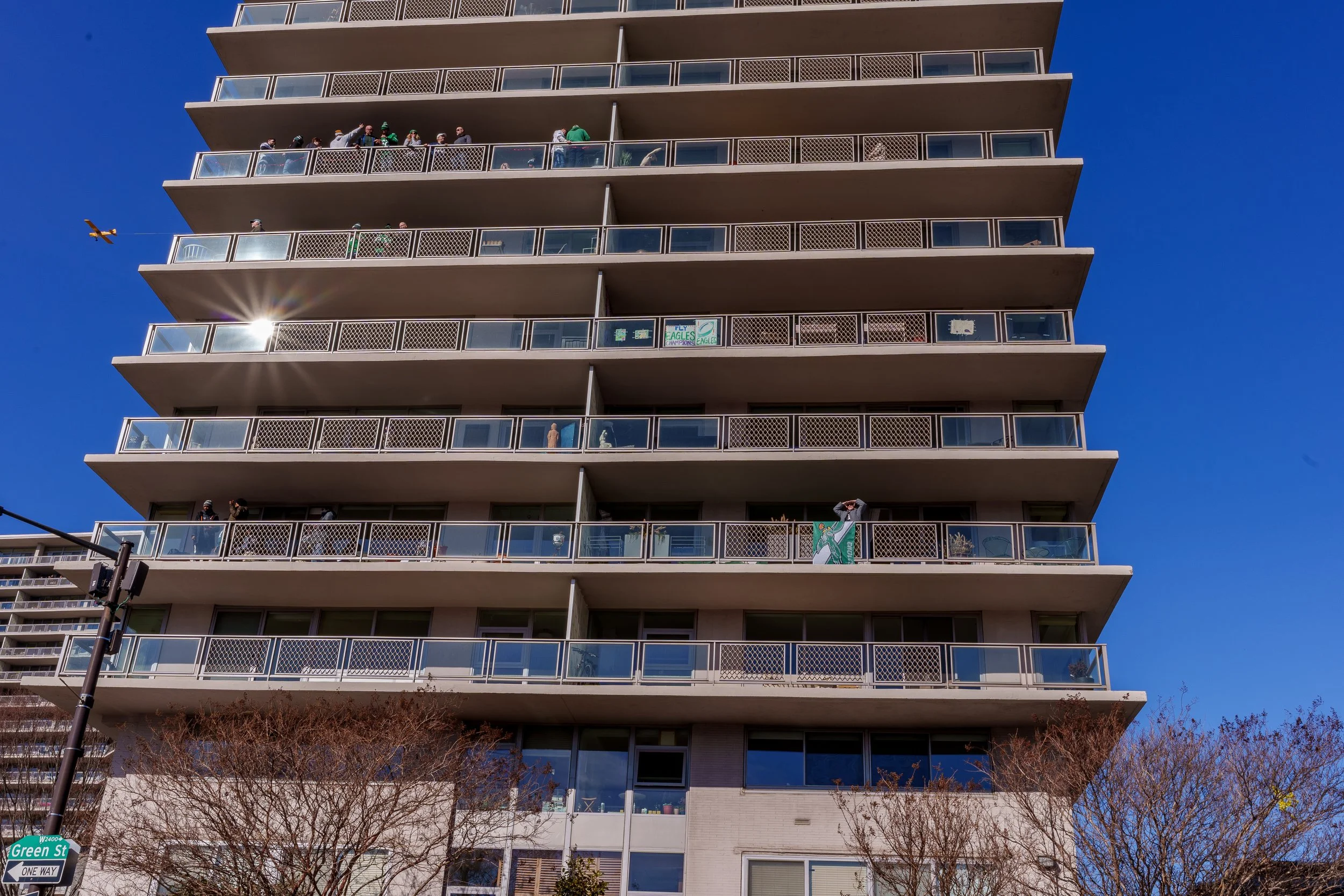 Fans watching from apartment balconies above the parade route