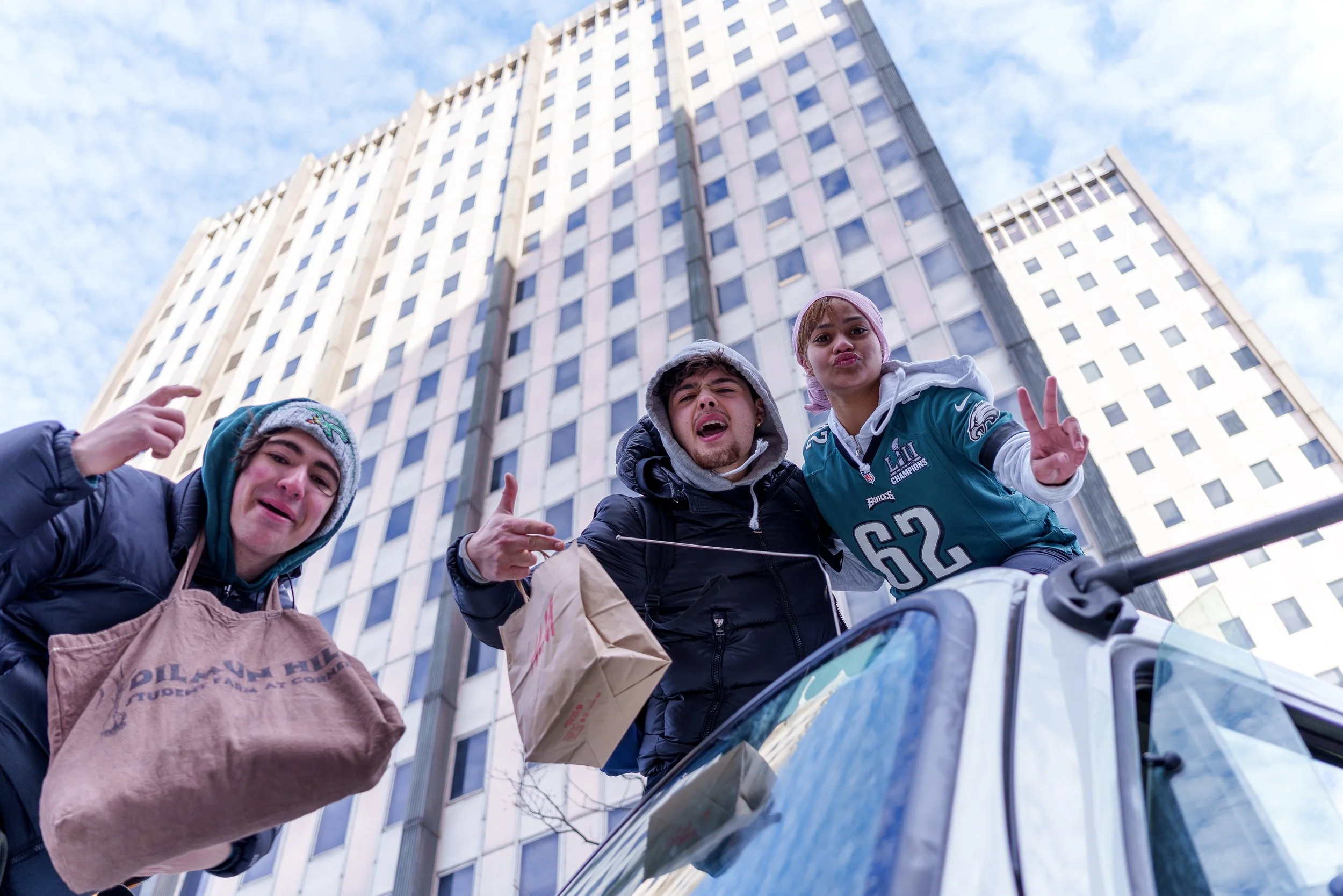 Fans celebrating below a tower on the parade route