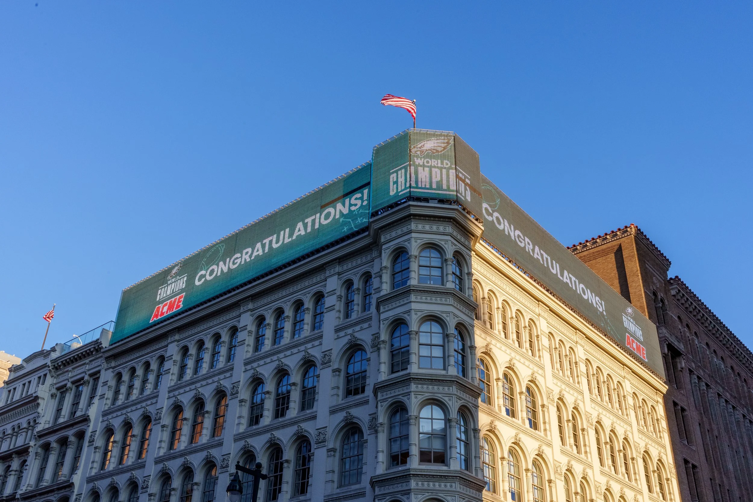 Congratulations Eagles banner wrapping a building on the parade route