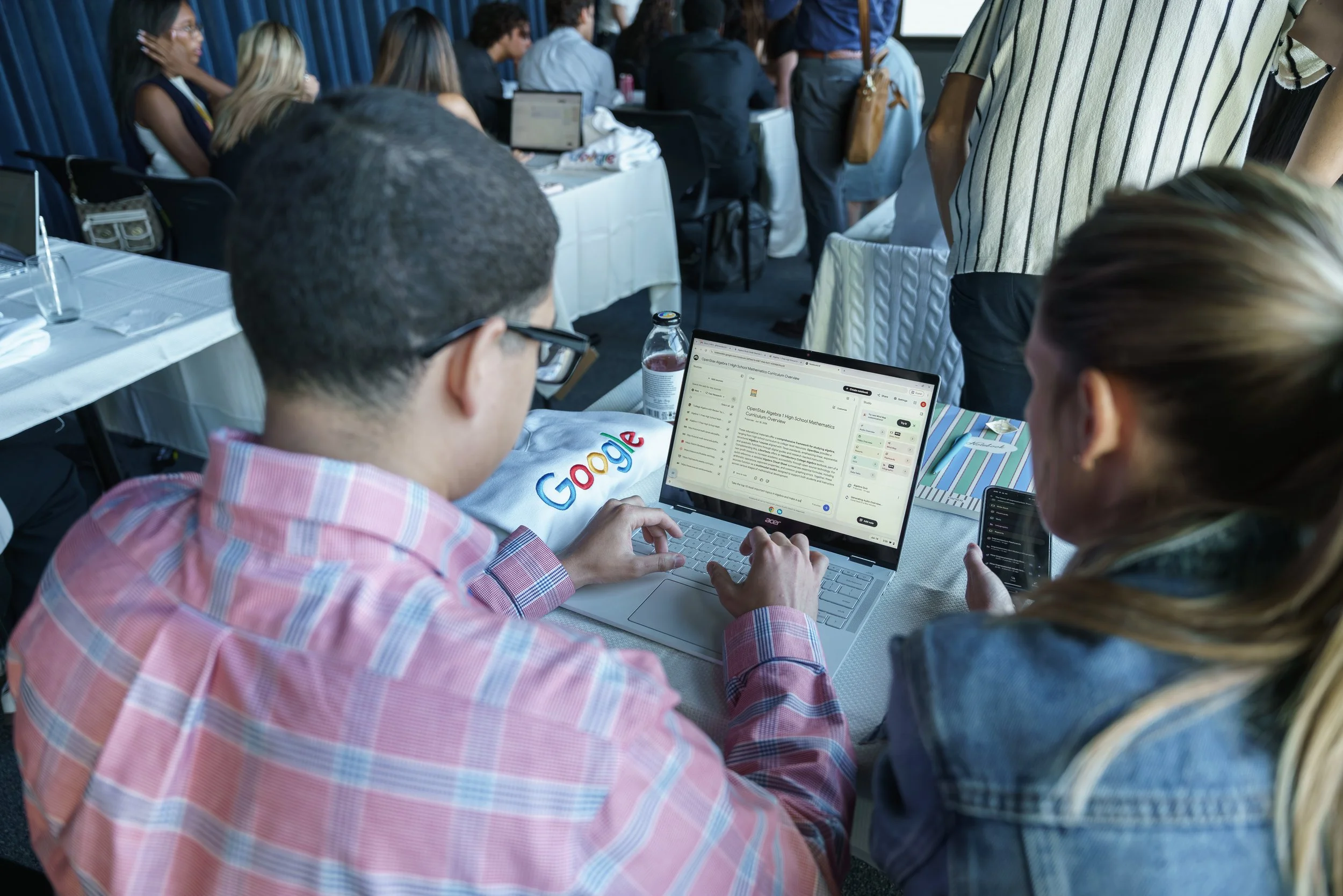 Heads together over a laptop