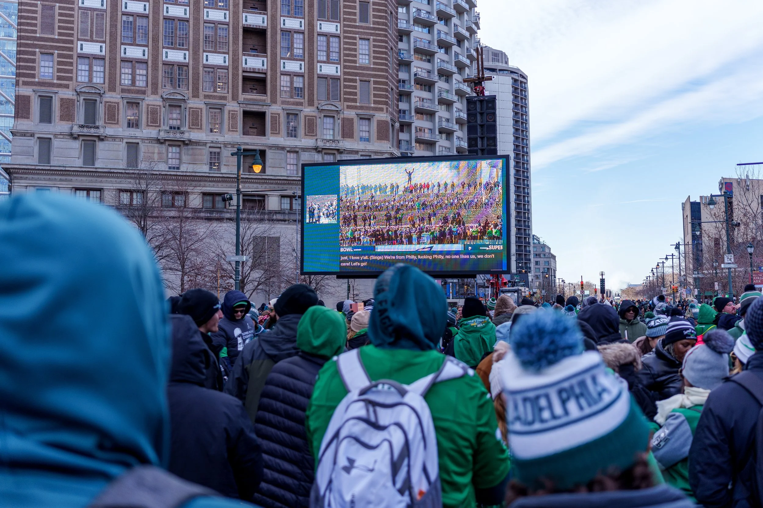 Crowd watching the parade on a large screen