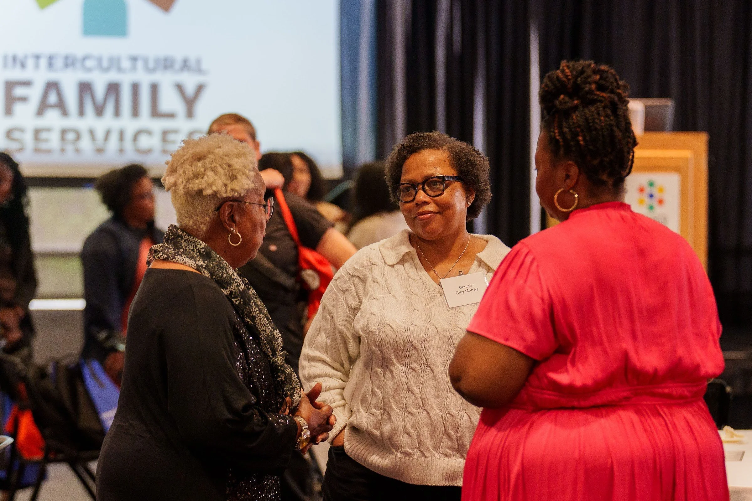 Attendees in conversation during the break