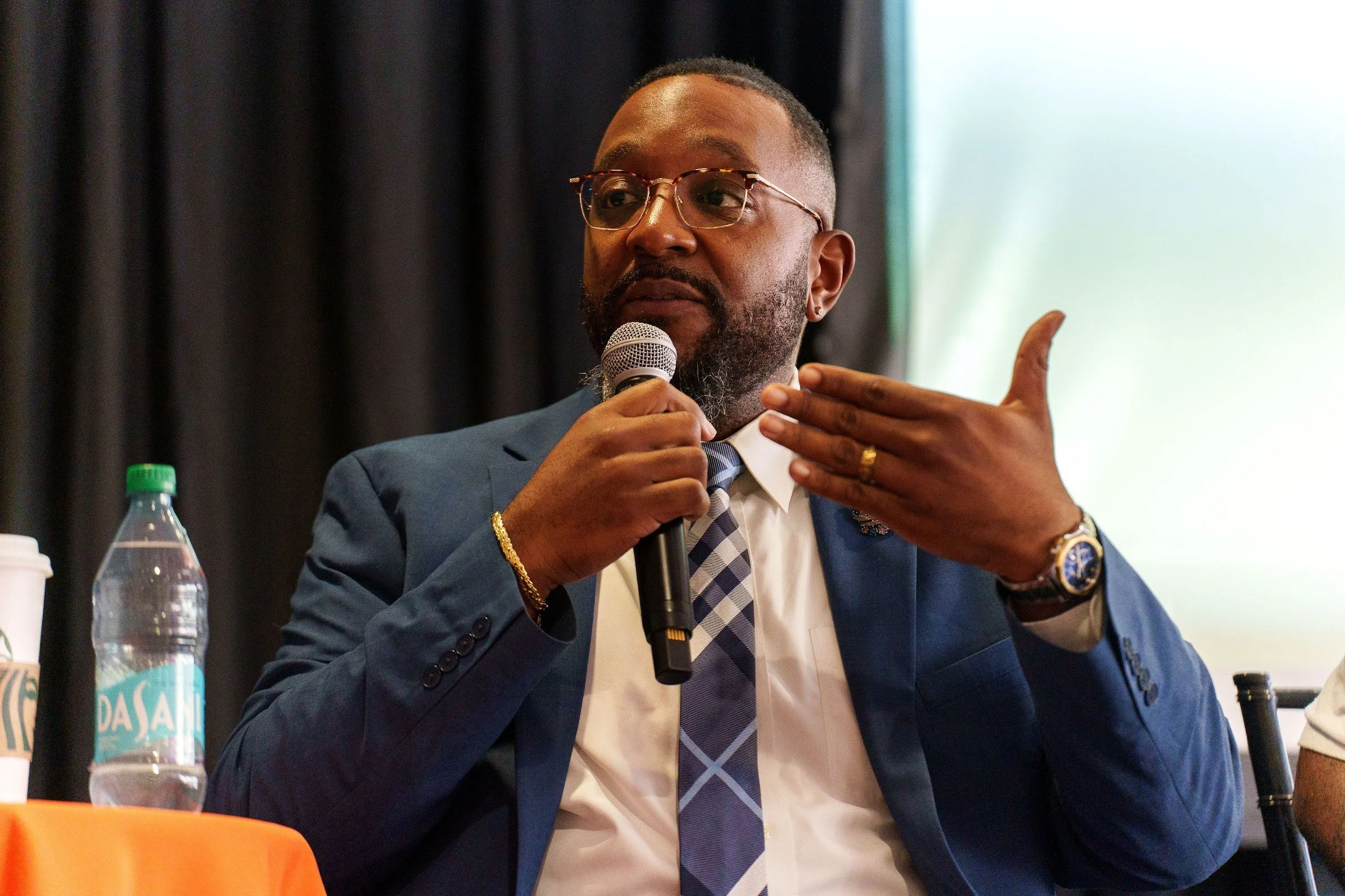 A panellist gesturing as he speaks