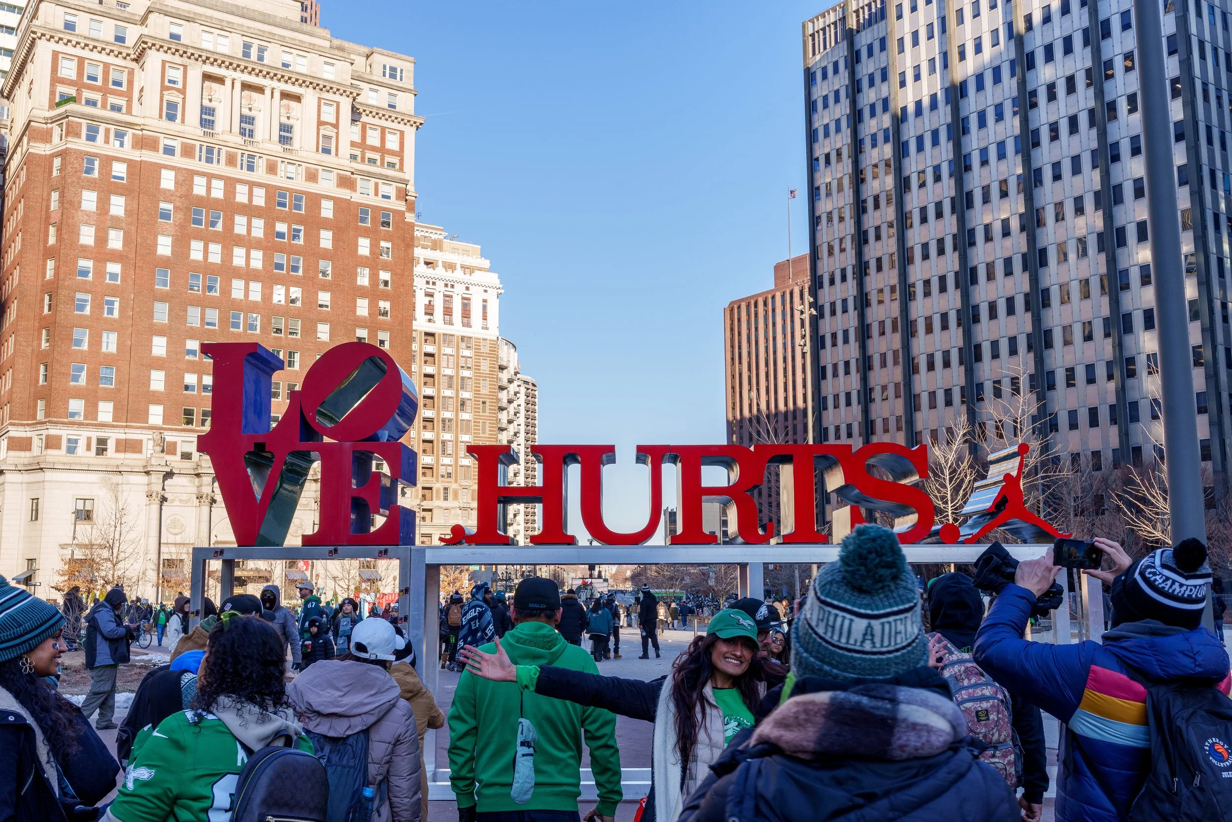 Crowd gathered at the LOVE HURTS. sculpture during the parade