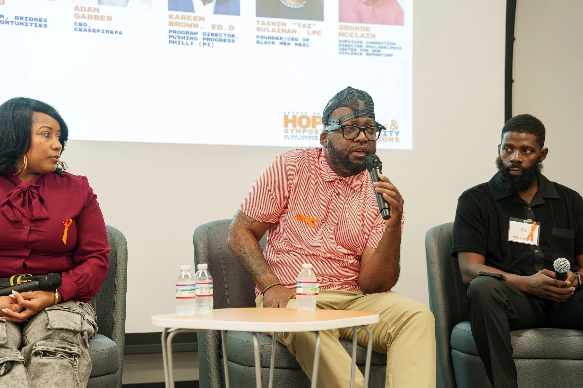 The panel seated before the audience
