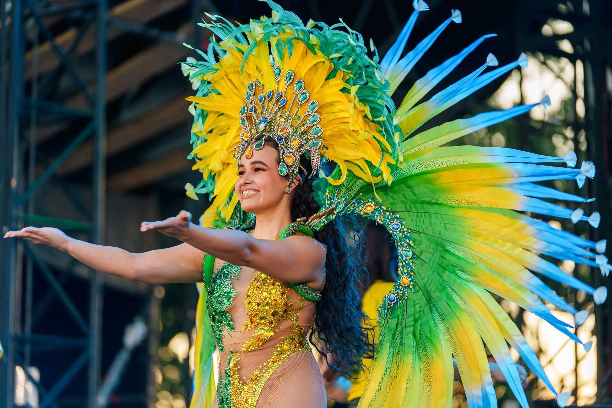A performer in carnival costume on the Fan Festival stage
